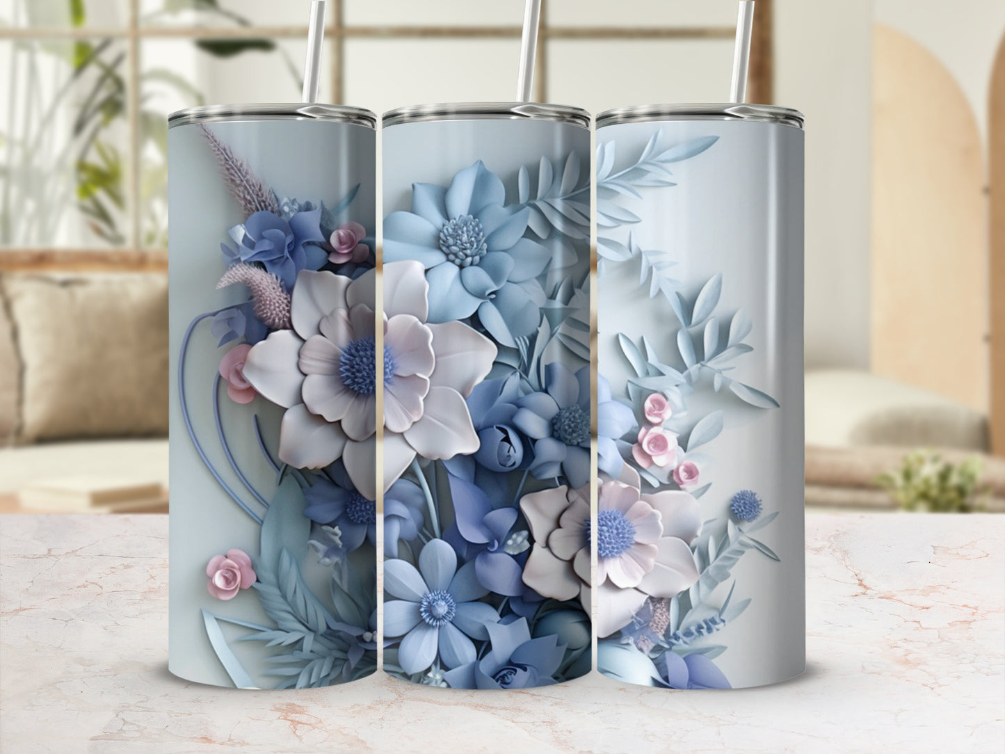 Three tumblers with pastel blue and pink floral designs.