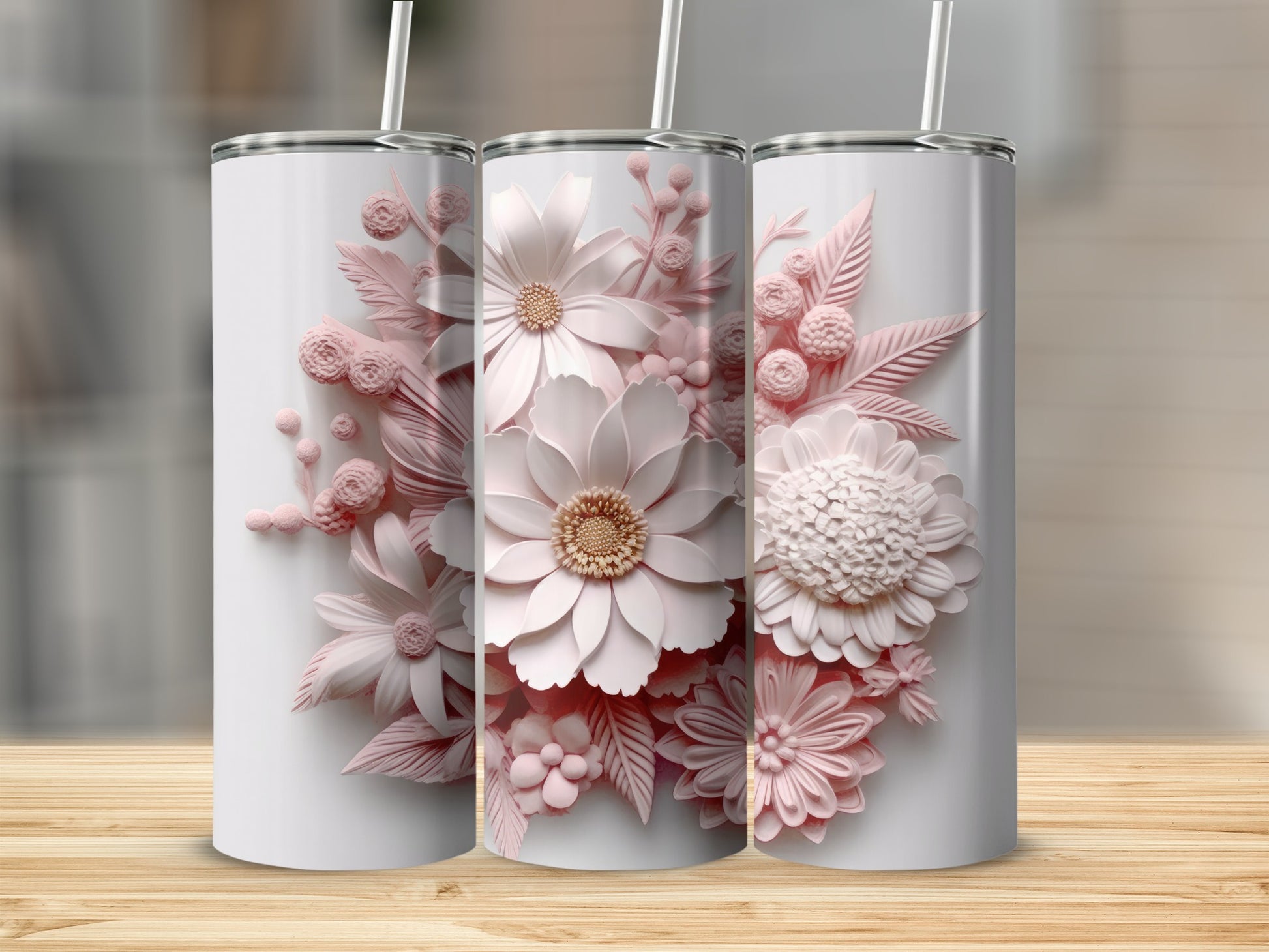 Three white tumblers with 3D pink floral designs and straws.