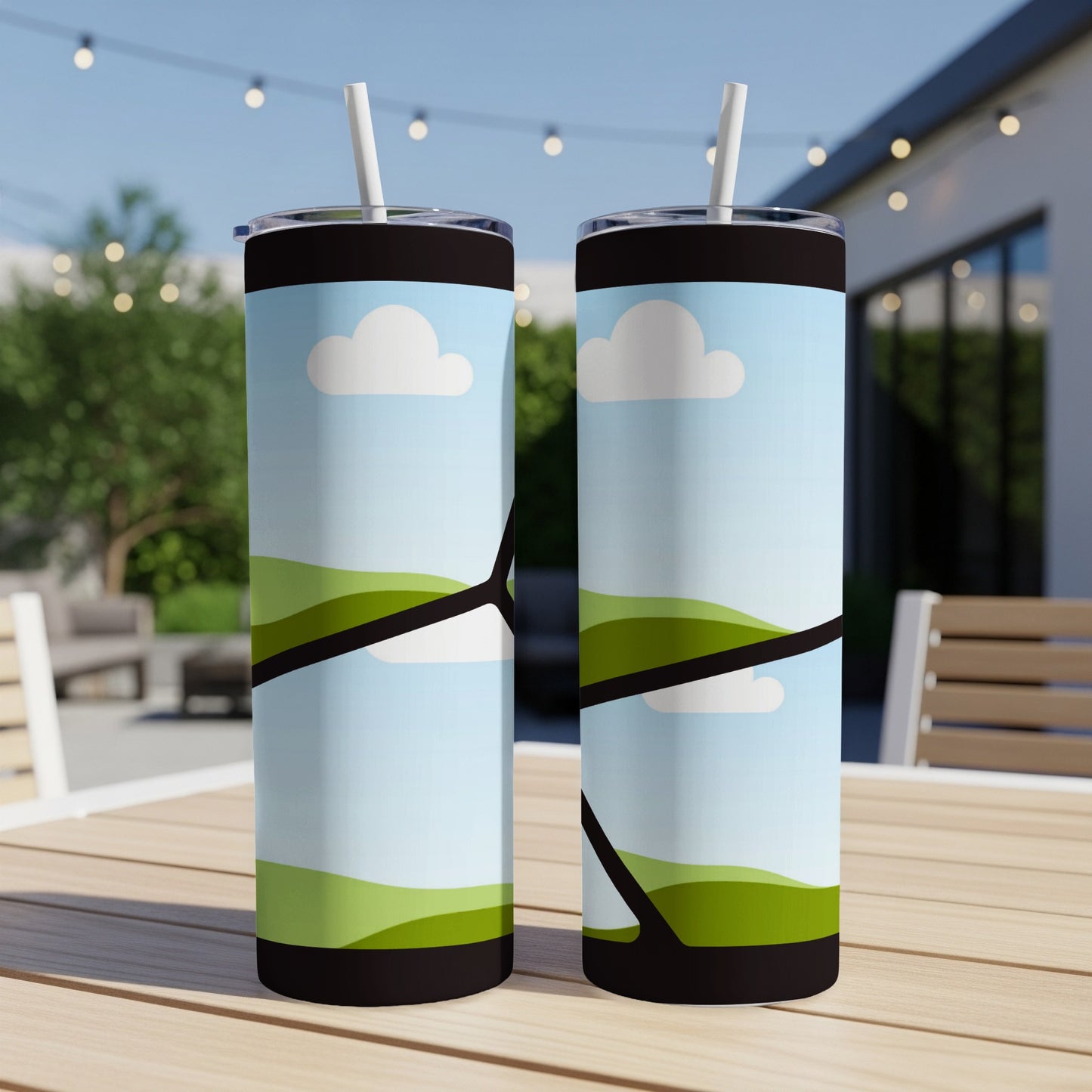 Two tall tumblers with a stylized landscape and cloud design.