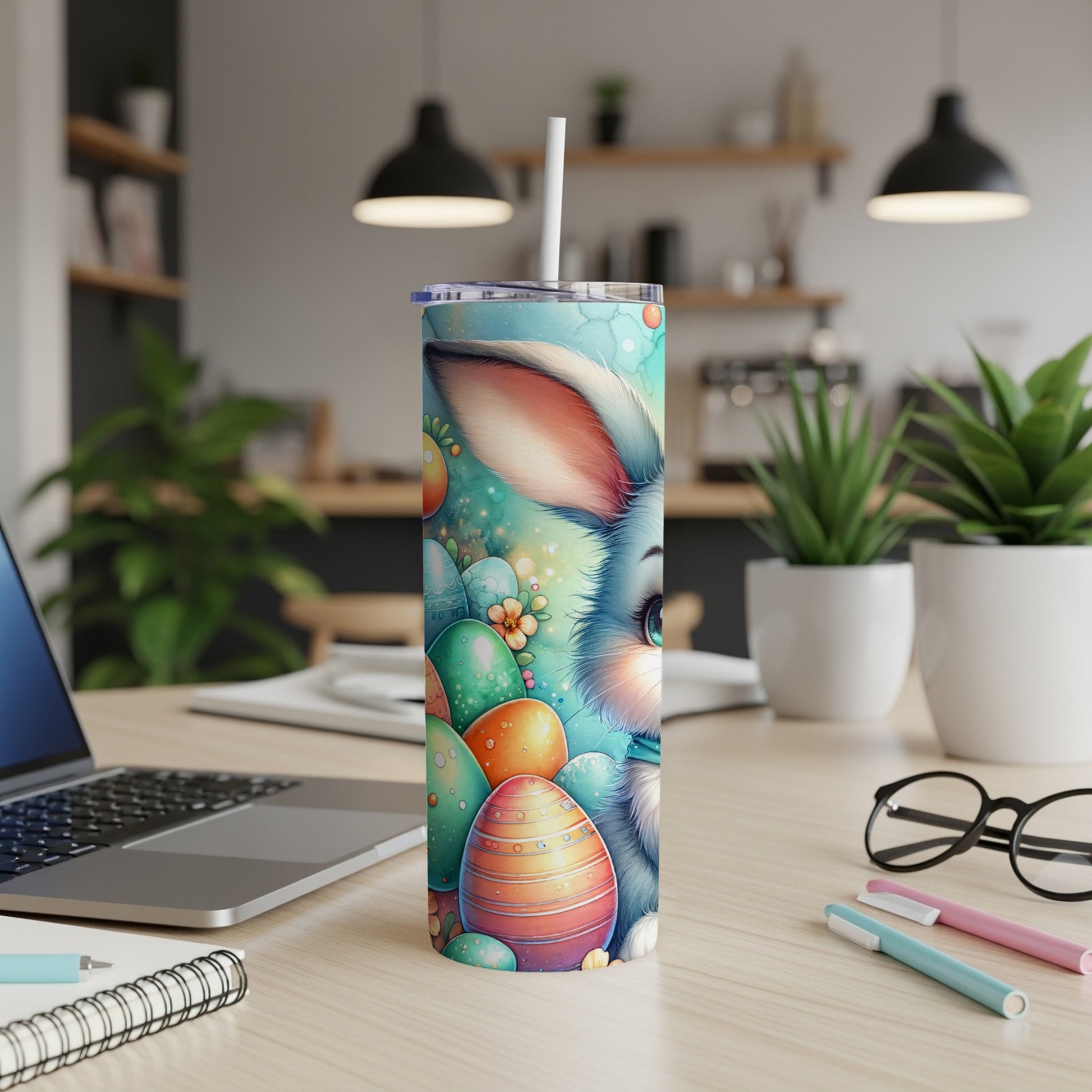 Easter bunny and colorful eggs on a blue patterned tumbler with straw.