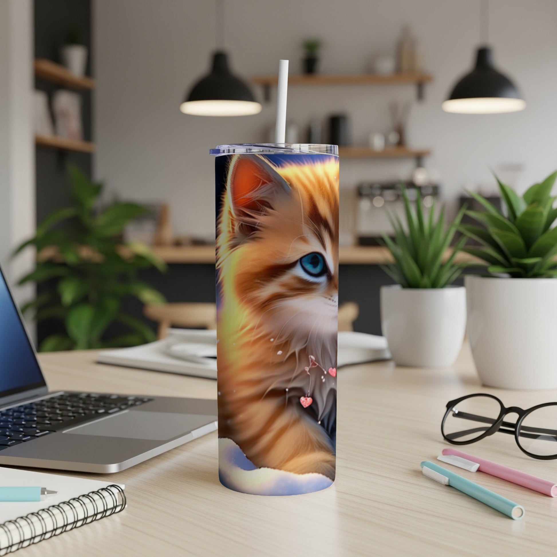 Orange tabby cat with blue eyes on a tumbler, with a straw.