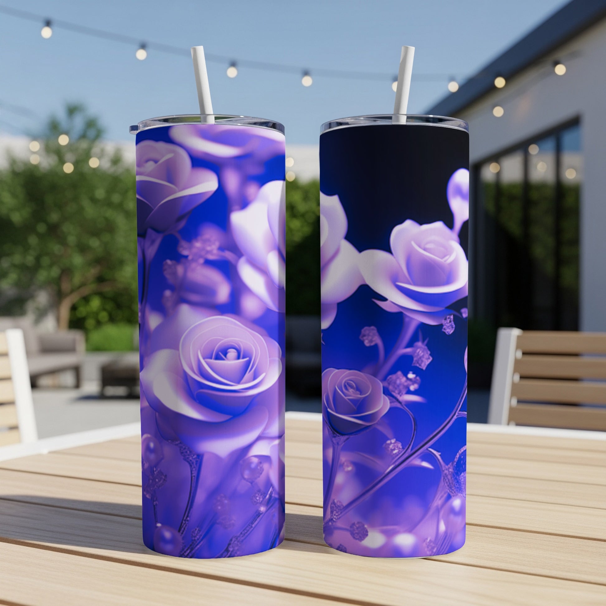 Two tumblers with a purple floral design sit on a table outdoors.