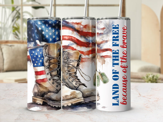 American flag, boots, and dog tags on a tumbler with "LAND OF THE FREE because of the brave" text.