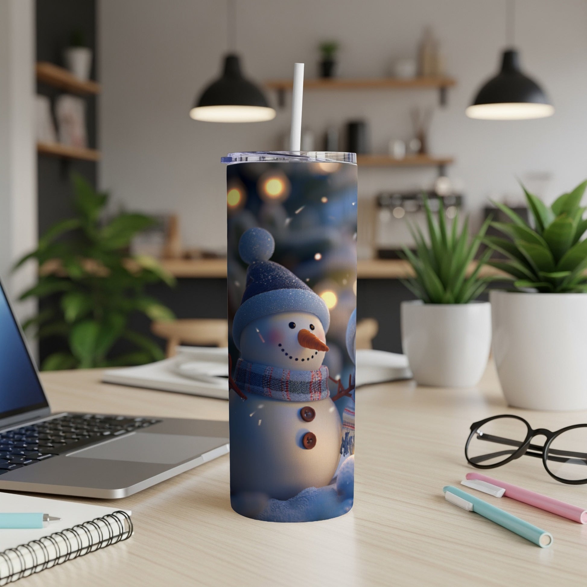 Snowman tumbler with lid and straw on a desk.