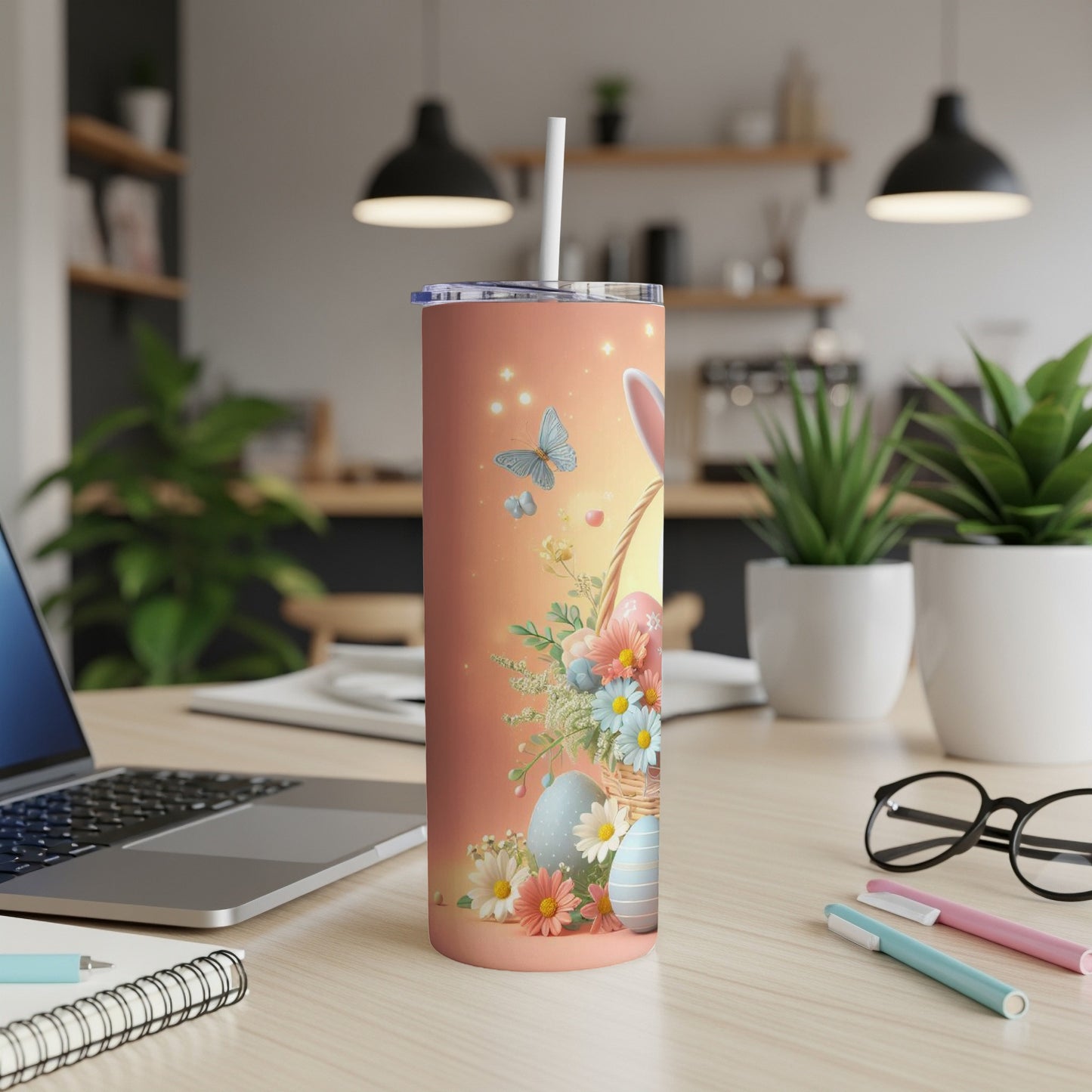 Easter bunny and eggs tumbler with floral design on a desk.