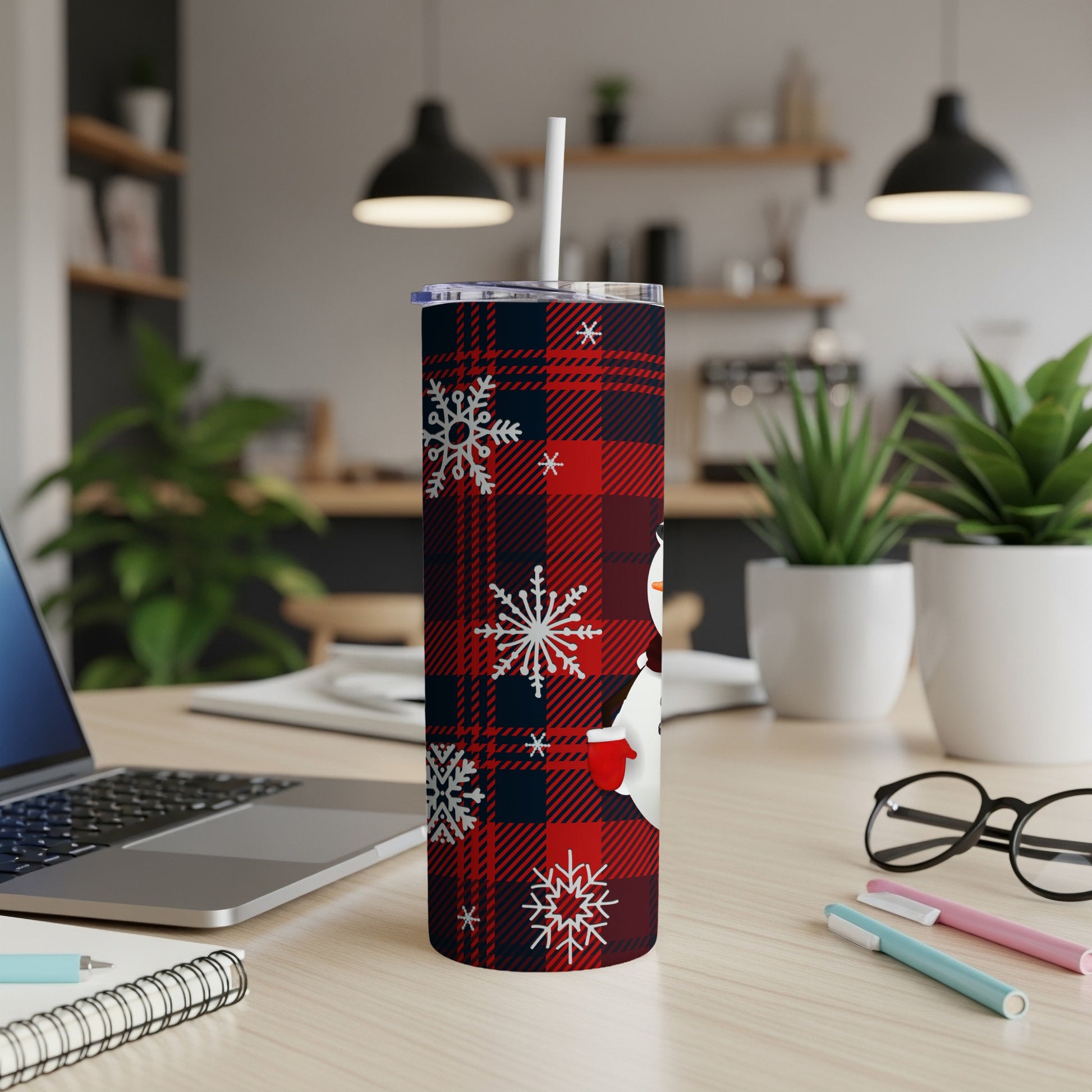 Red plaid tumbler with snowman and snowflake design and a straw.