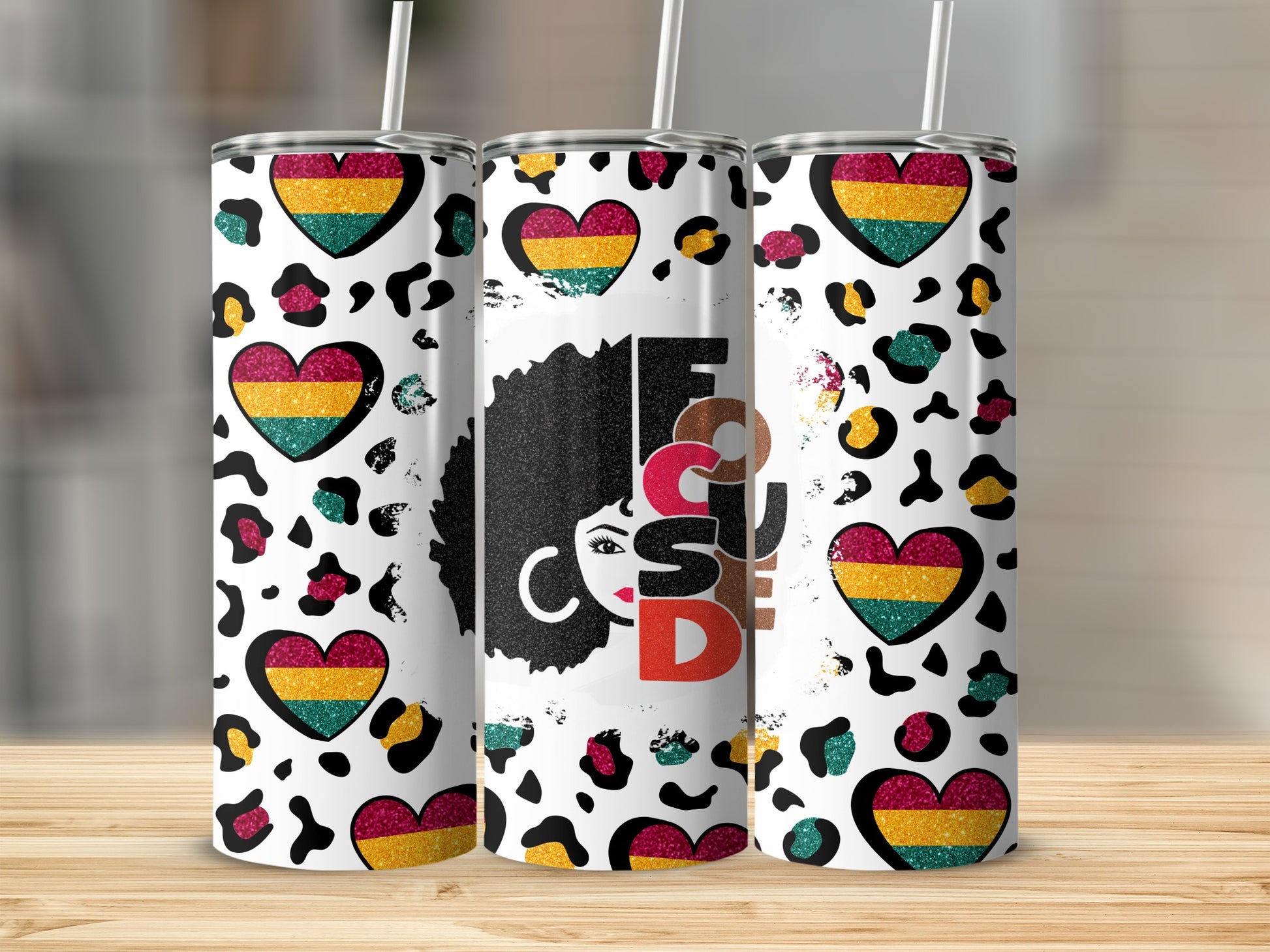 Trio of tumblers with leopard print, hearts, and "Focus" text.