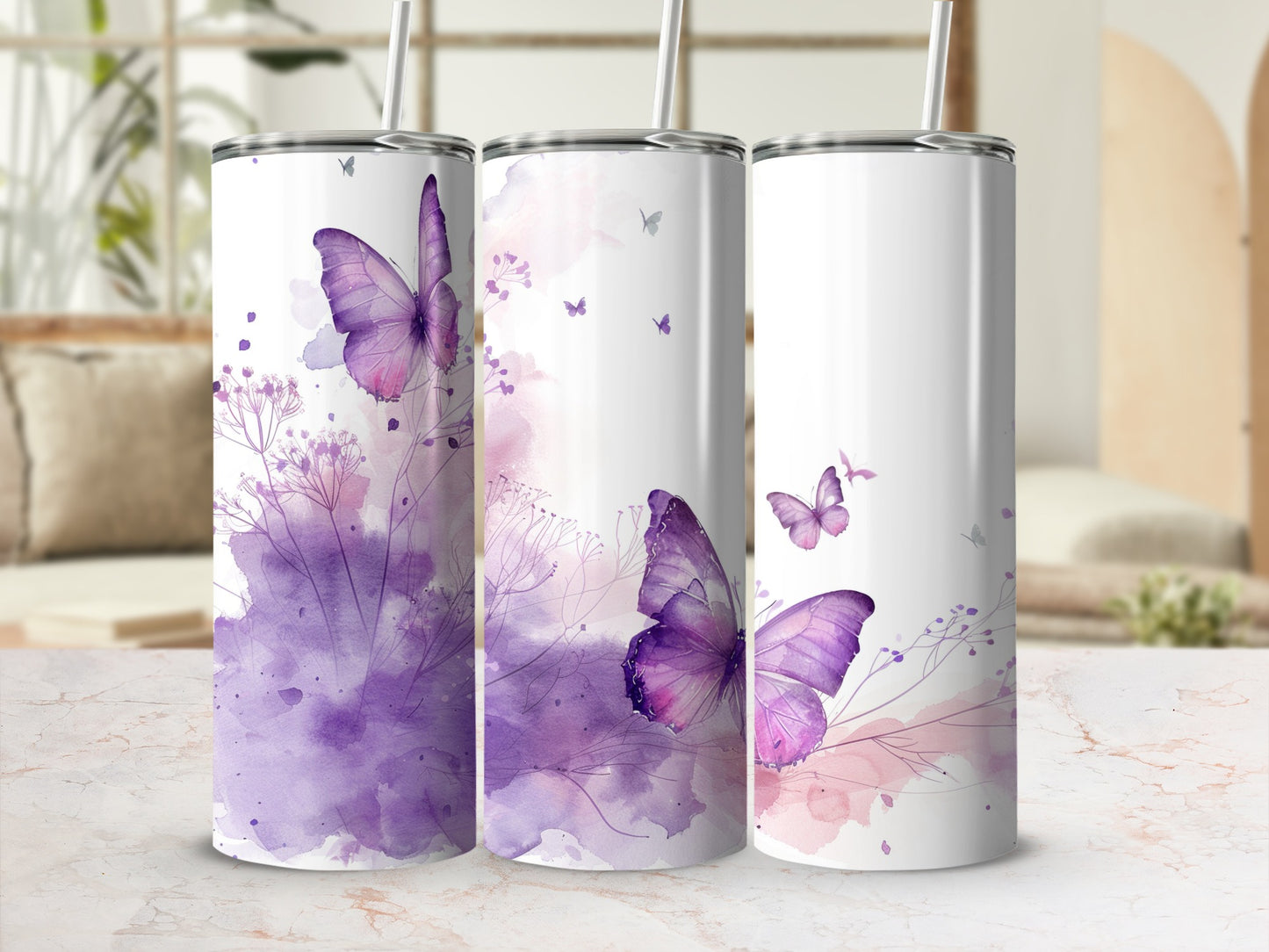 Three tumblers with watercolor butterfly and floral designs in purple and pink.