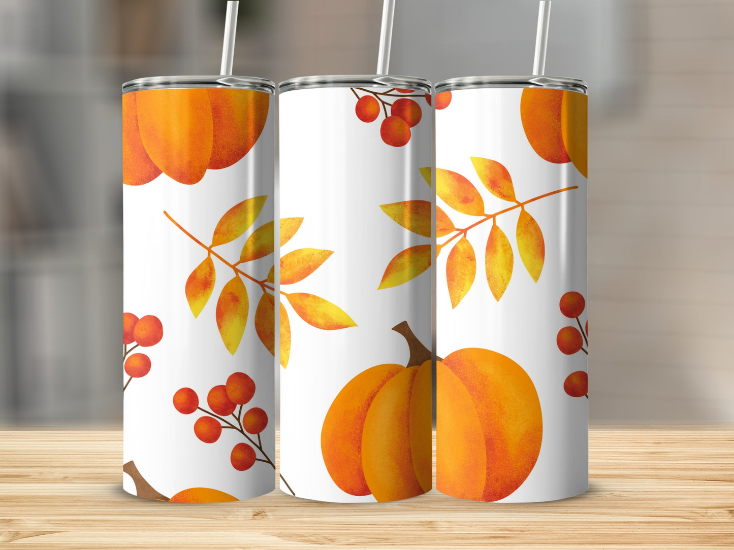 Three tumblers with a fall theme featuring pumpkins, leaves, and berries.