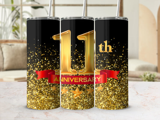 Black tumbler with "11th ANNIVERSARY" on a red ribbon with gold stars and glitter.