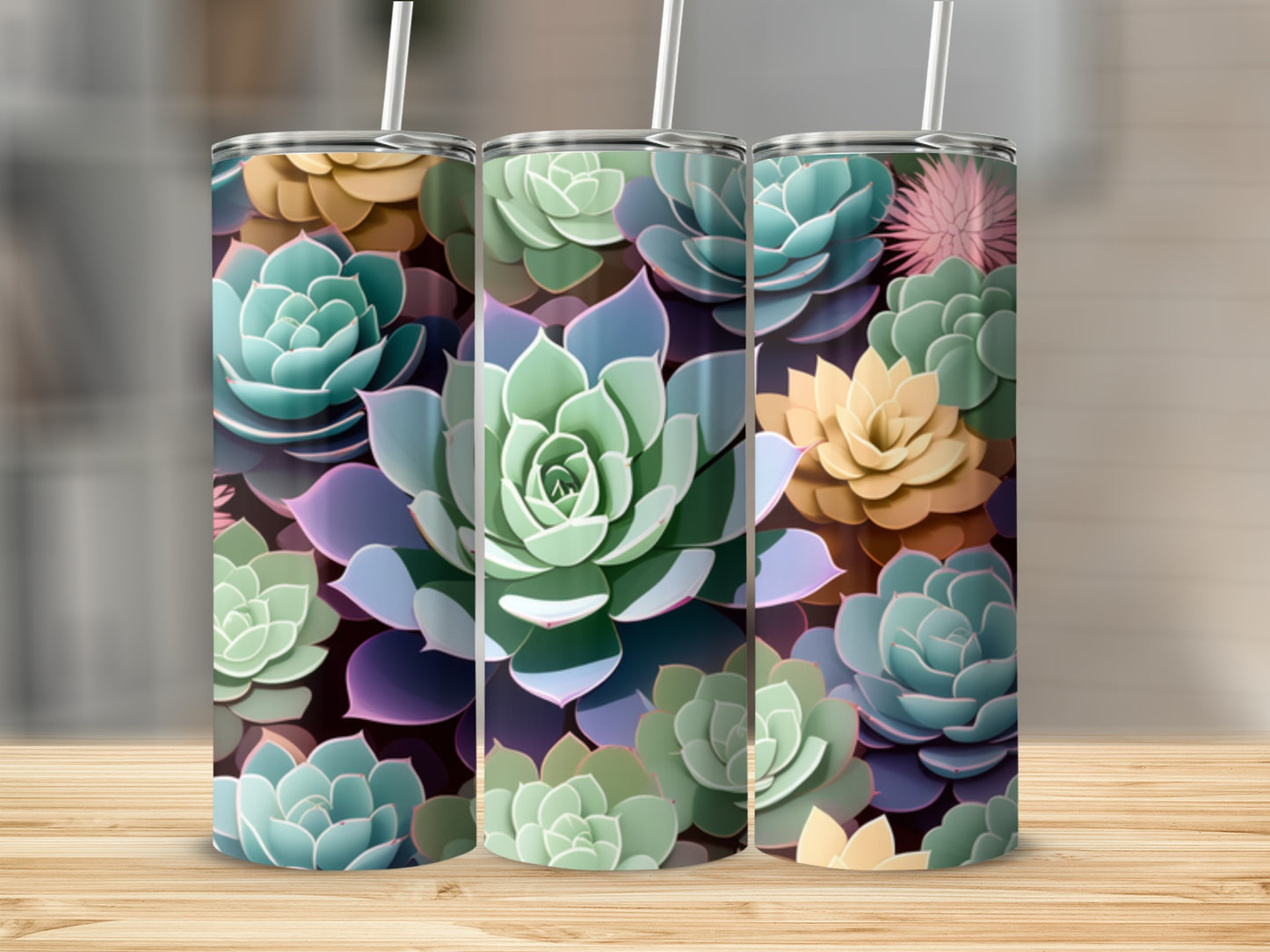 Three tumblers with a colorful succulent plant pattern on a wooden surface.