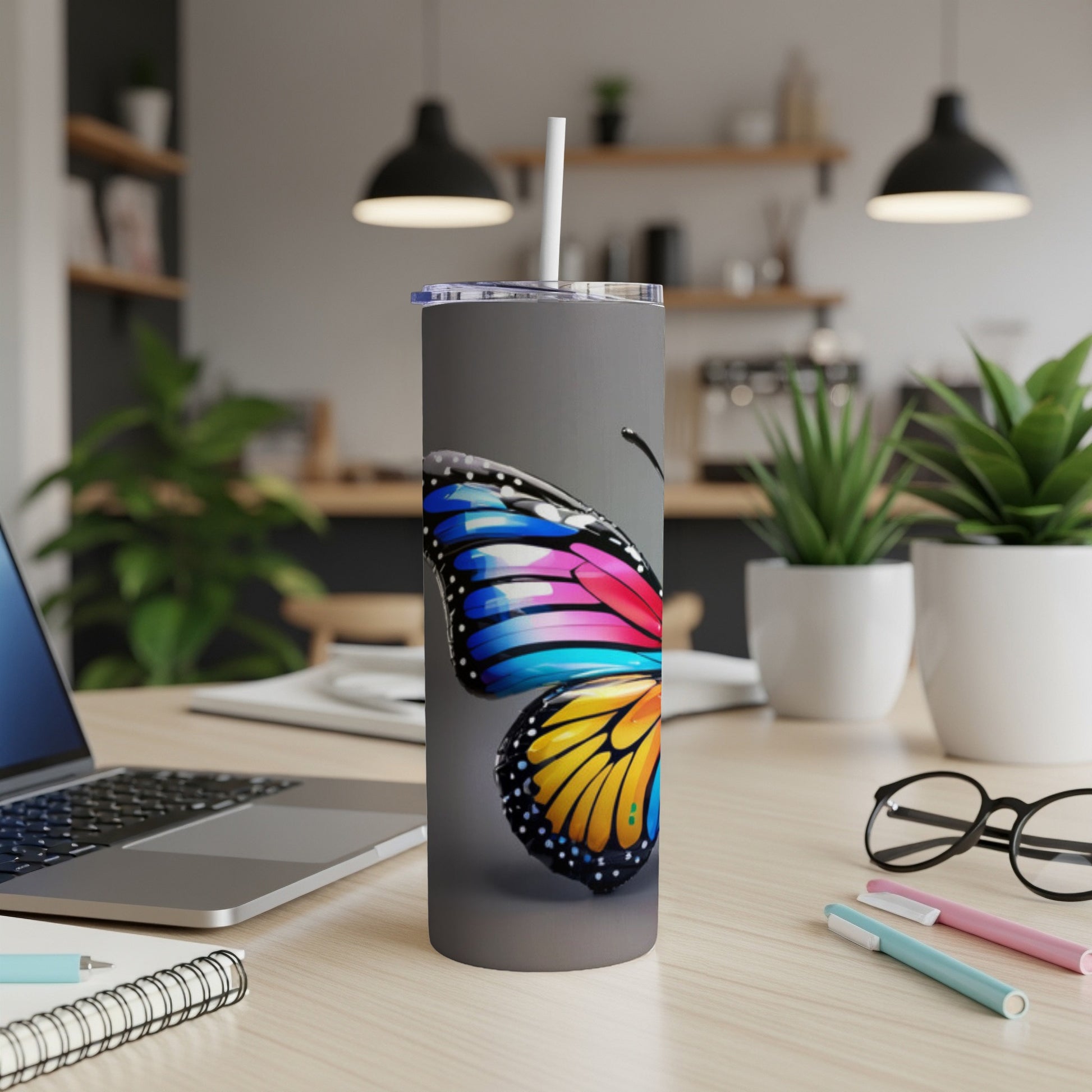 Gray tumbler with a colorful butterfly design.