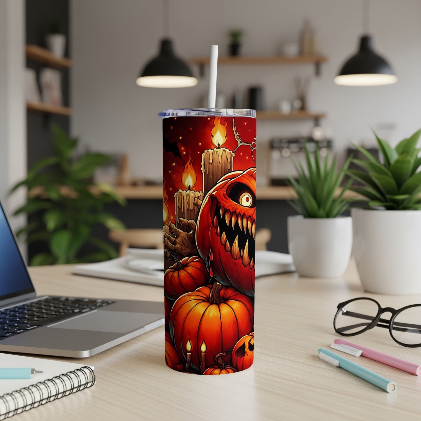 Tumbler with scary jack-o'-lanterns, pumpkins, and candles on a dark background.