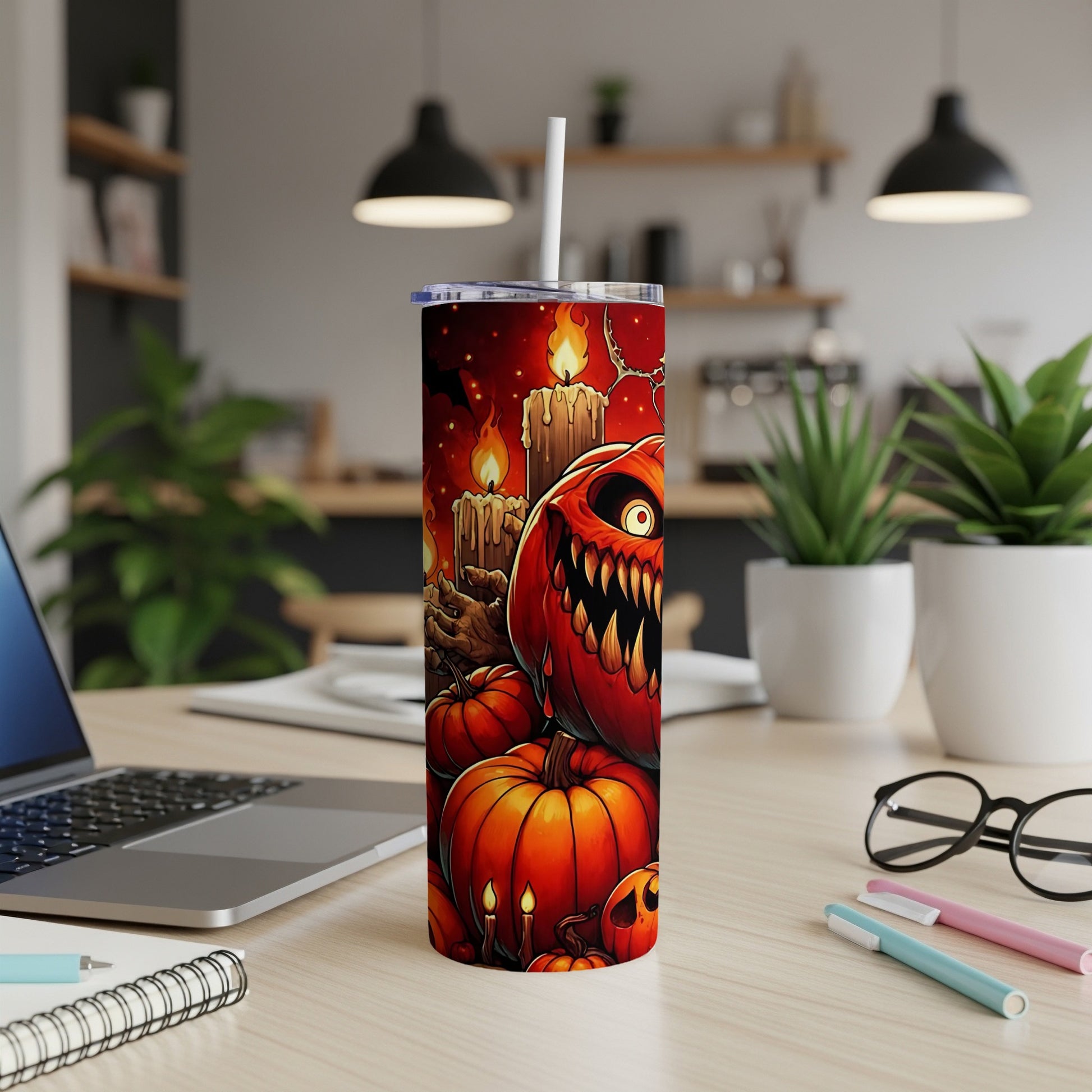 Tumbler with scary jack-o'-lanterns, pumpkins, and candles on a dark background.