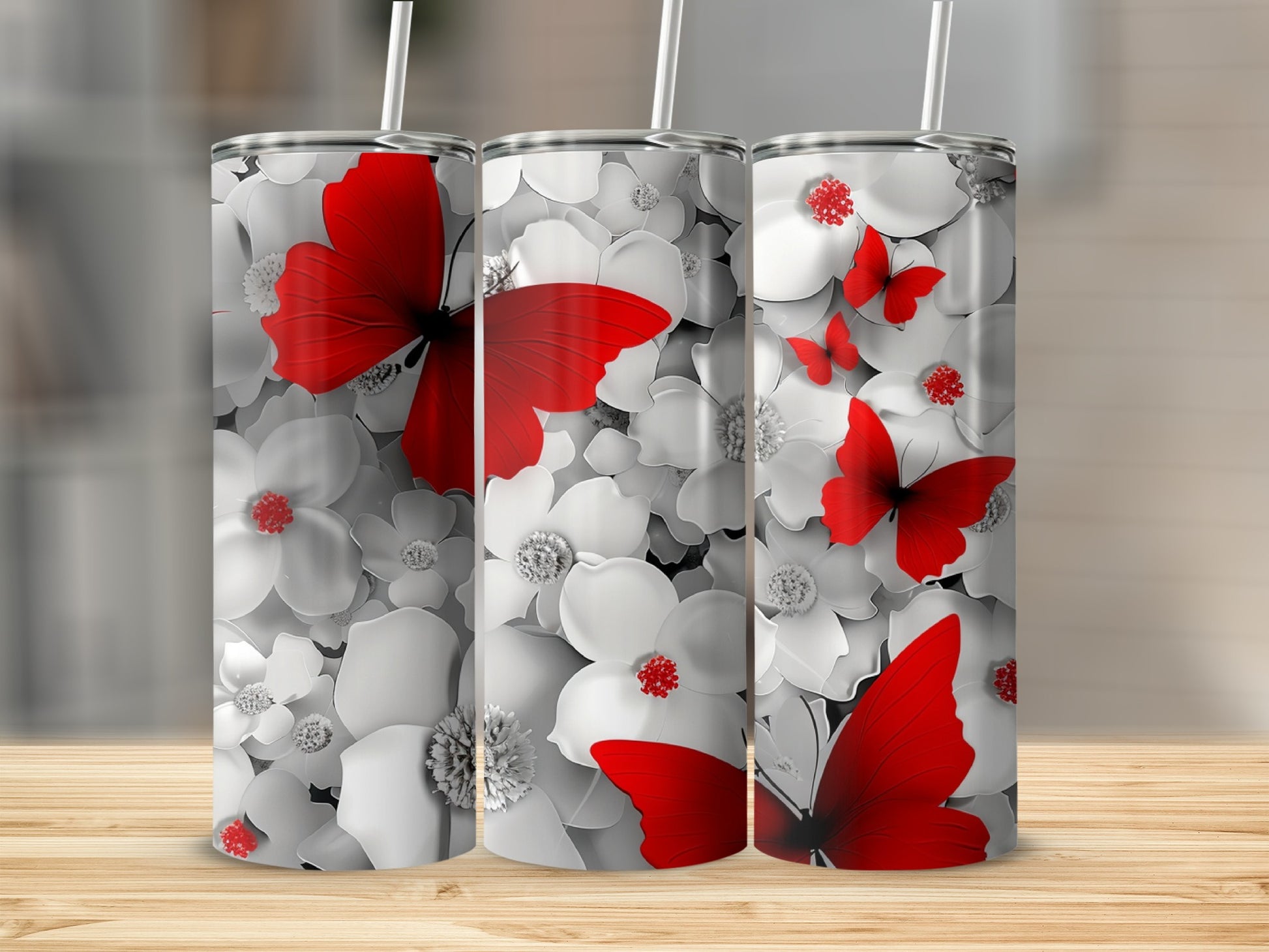 Three tumblers with red butterflies and white floral patterns.