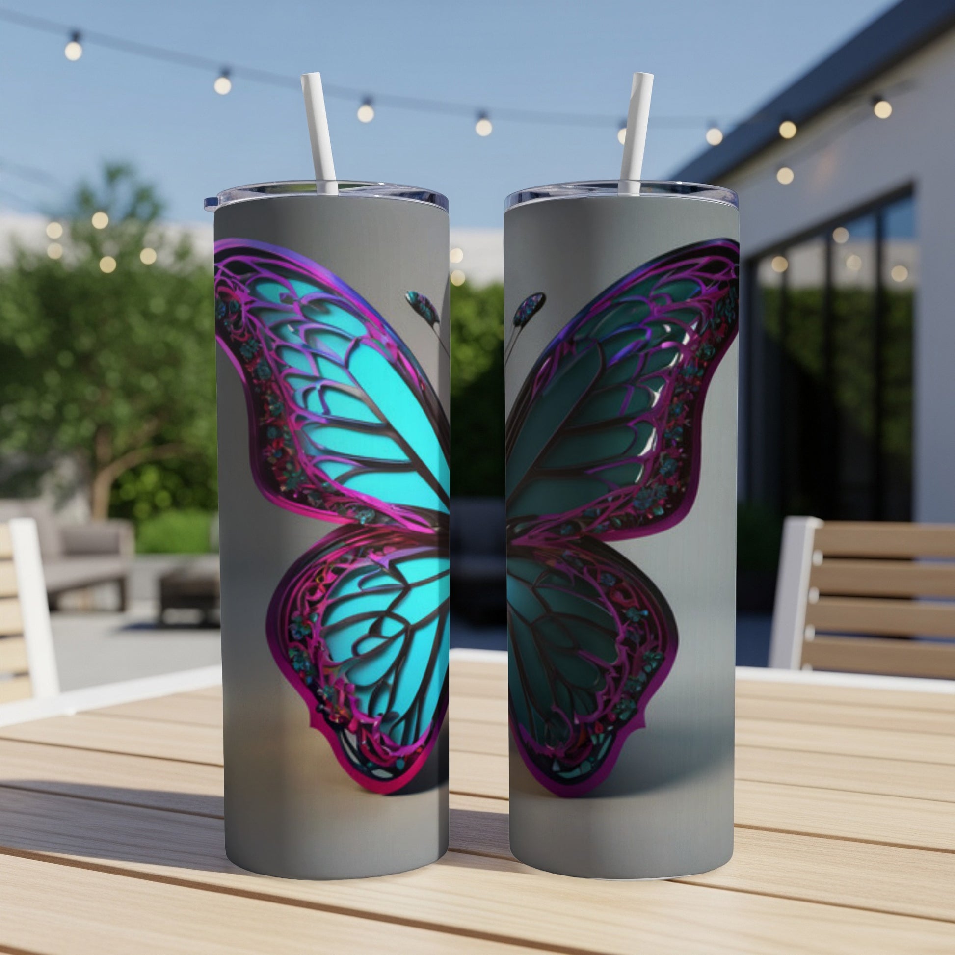 Two tumblers with a teal and purple butterfly design on a wooden table.