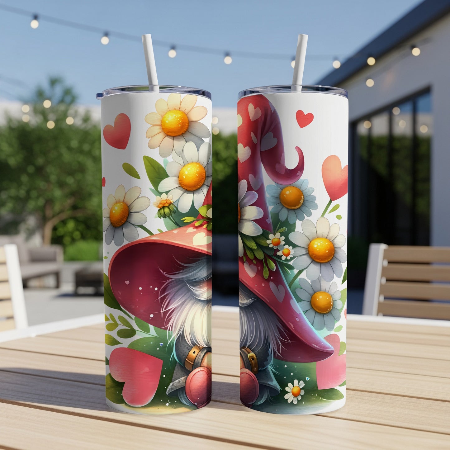 Two white tumblers with gnome and floral designs, sitting on a wooden table.