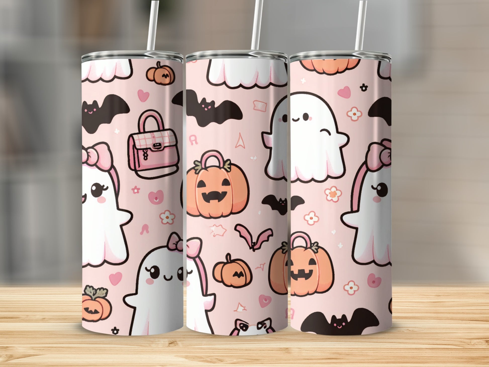 Three tumblers with a pink, Halloween-themed pattern of ghosts, pumpkins, and bats.