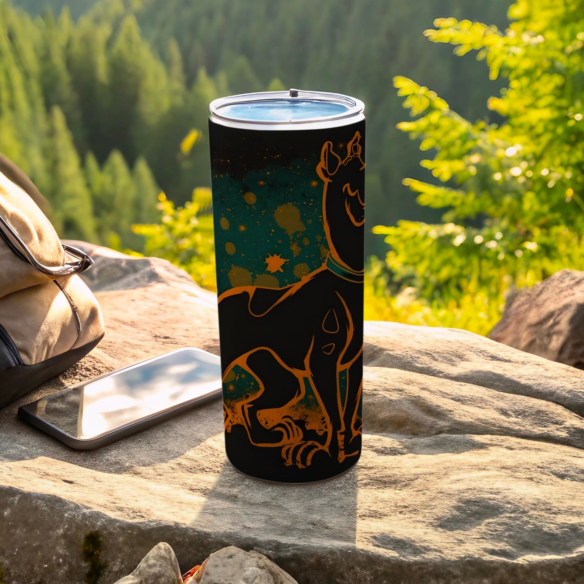 Black tumbler with Scooby-Doo graphic and orange speckles, outdoors.