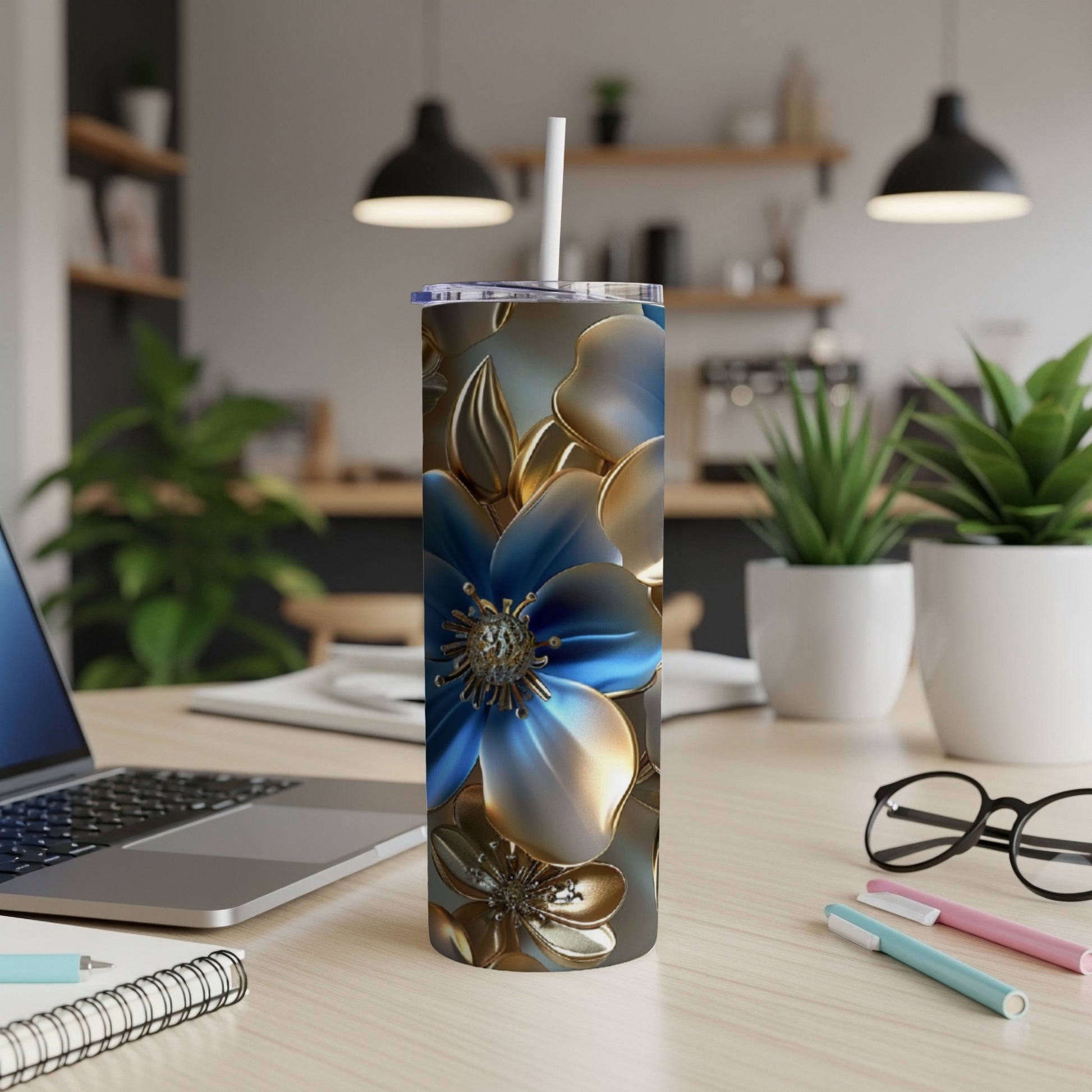 Floral pattern on a tall, slender tumbler with a white straw on a desk.