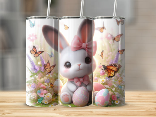 Cute Easter bunny with pink bow, butterflies, and painted eggs on a tumbler.