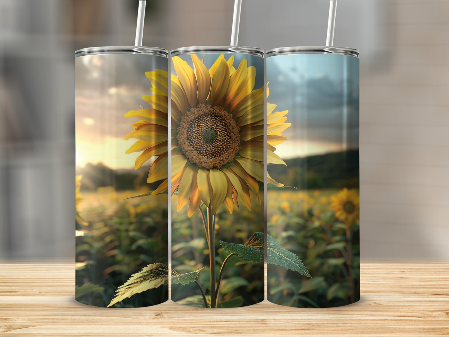 Three tumblers with a sunflower design stand on a wooden surface.