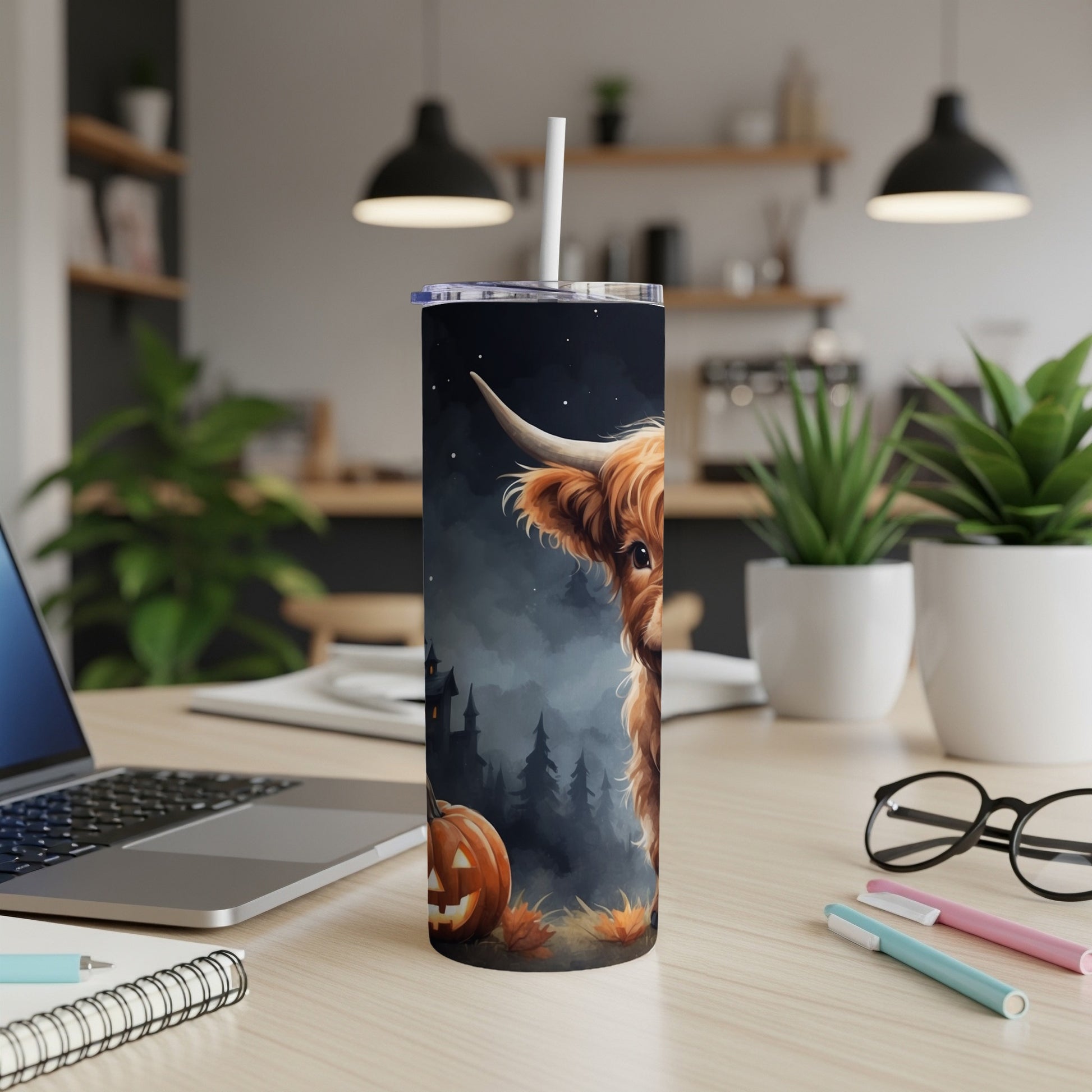 Highland cow and jack-o'-lantern Halloween design on a tumbler.