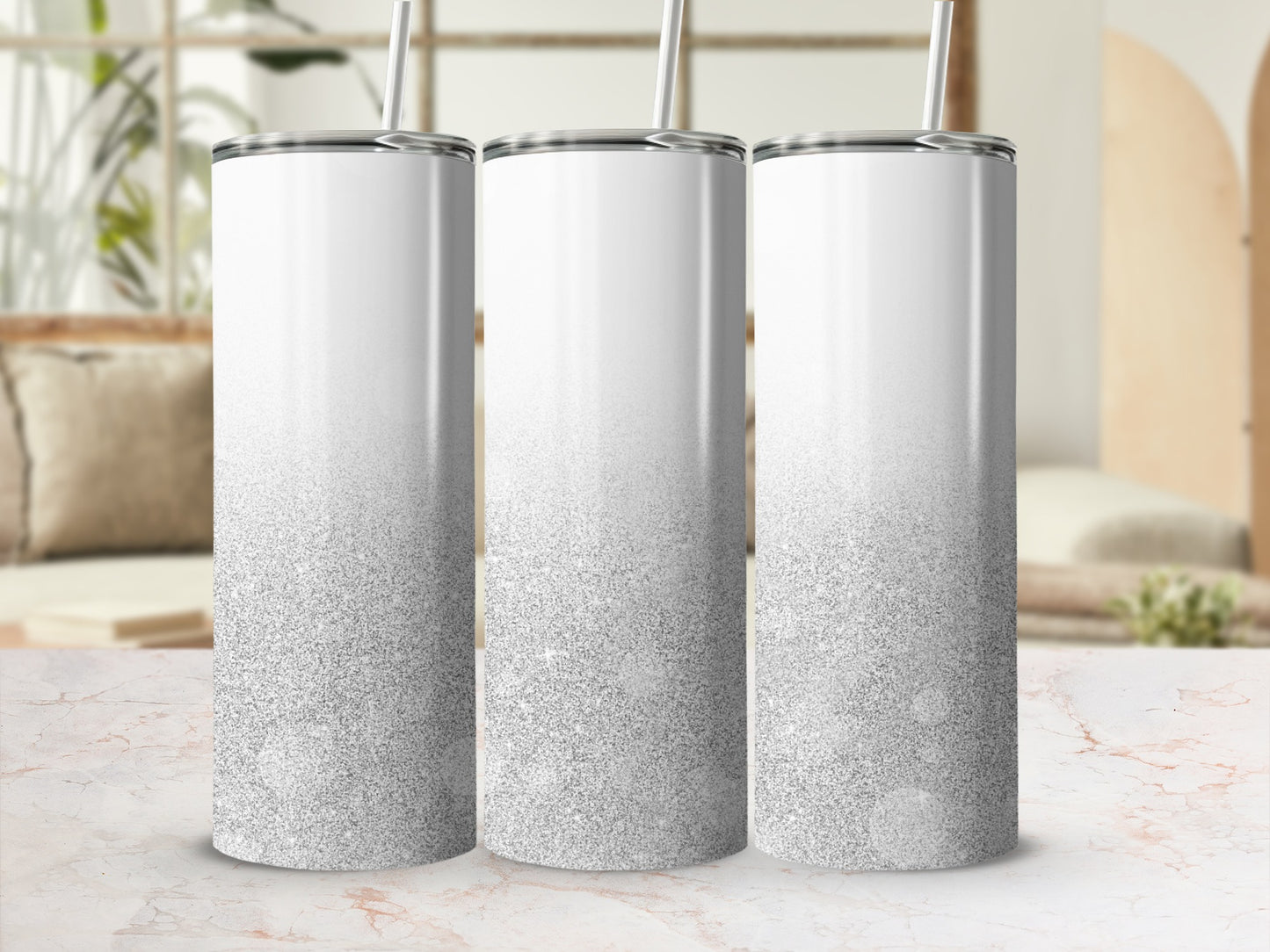 Three white tumblers with silver glitter gradient, on a marble surface.