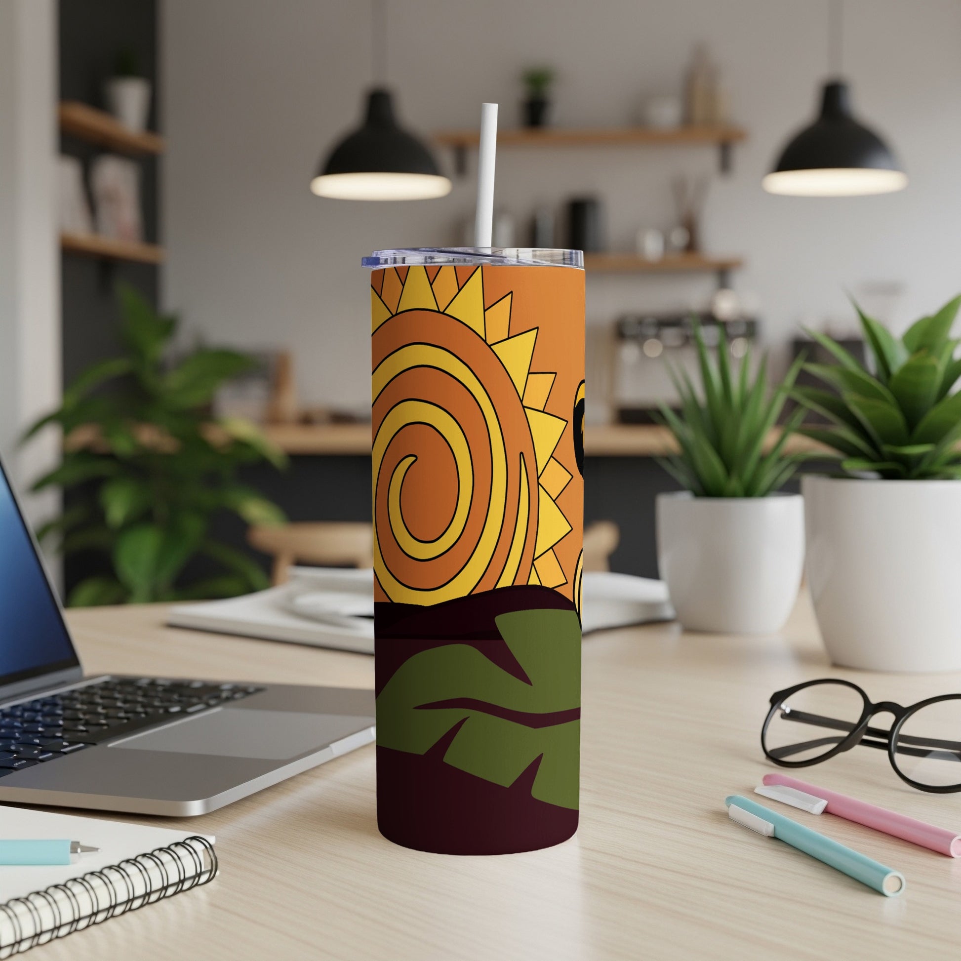 Orange and yellow abstract sun design on a white tumbler with a straw.