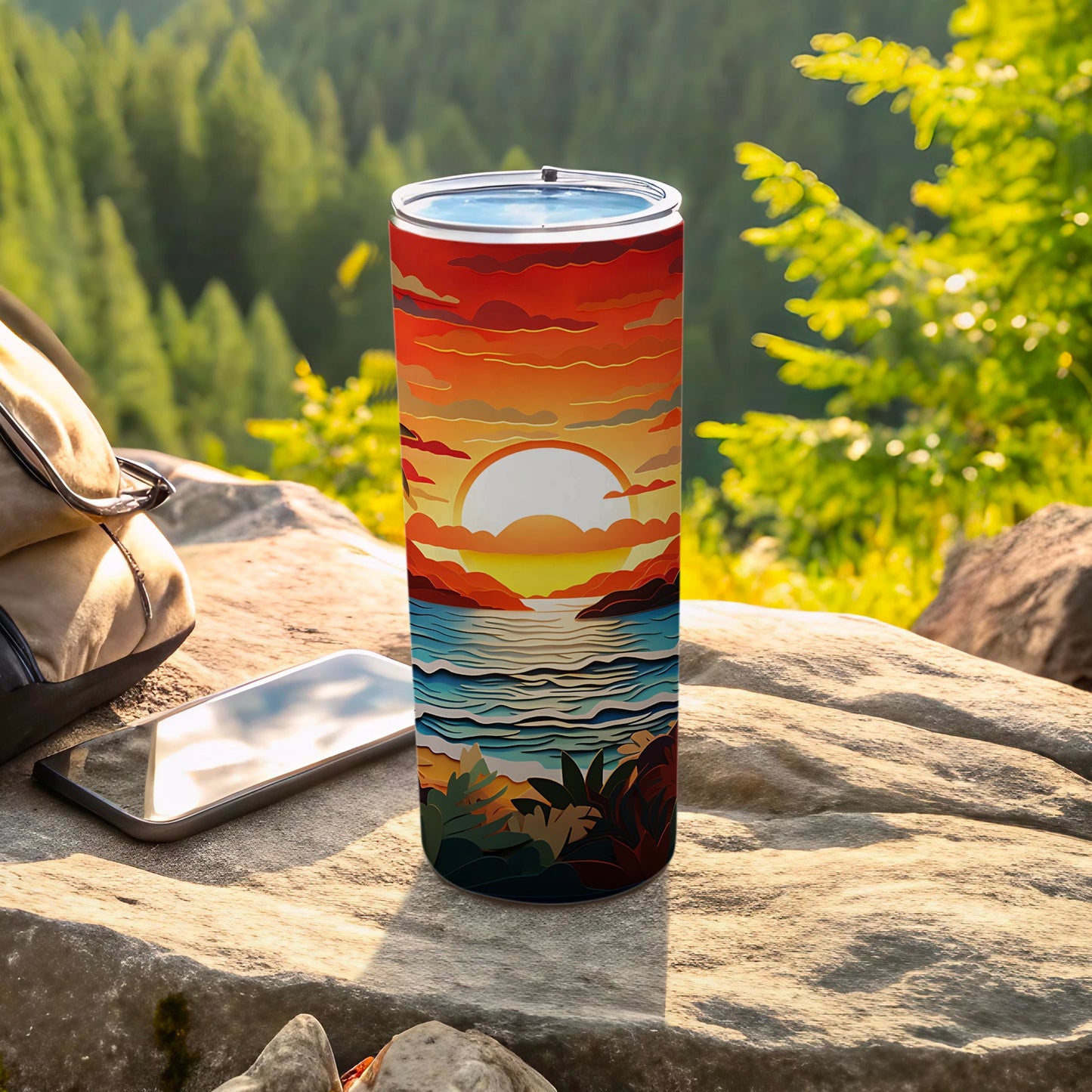 Sunset beach scene on a slim insulated tumbler with a phone and backpack.
