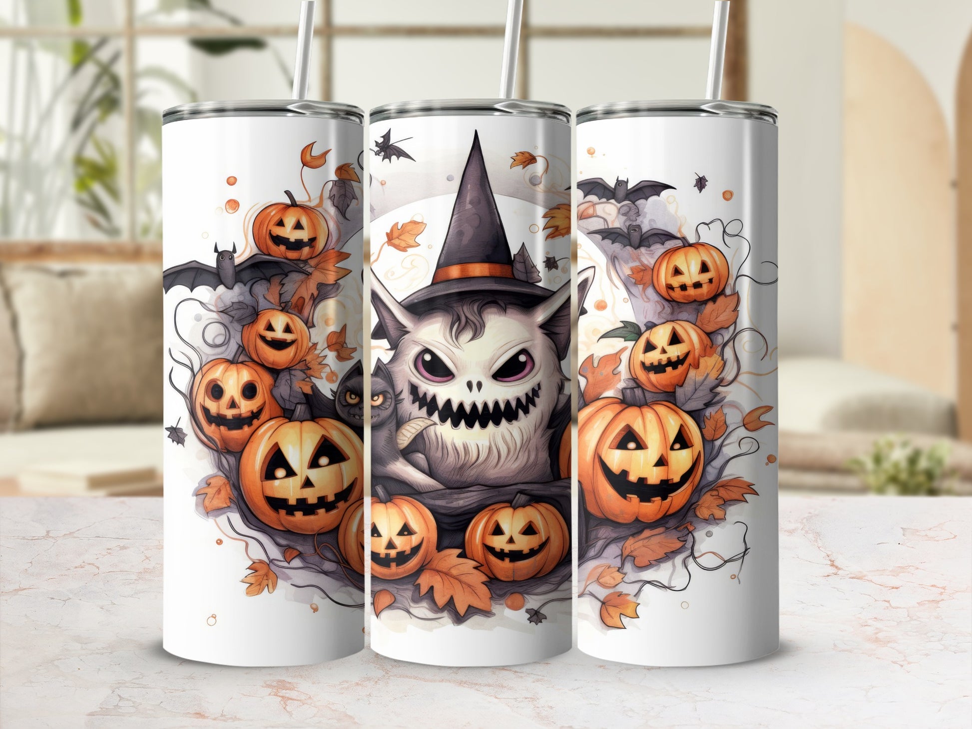 Three tumblers featuring a Halloween design with pumpkins, bats, and a monster.