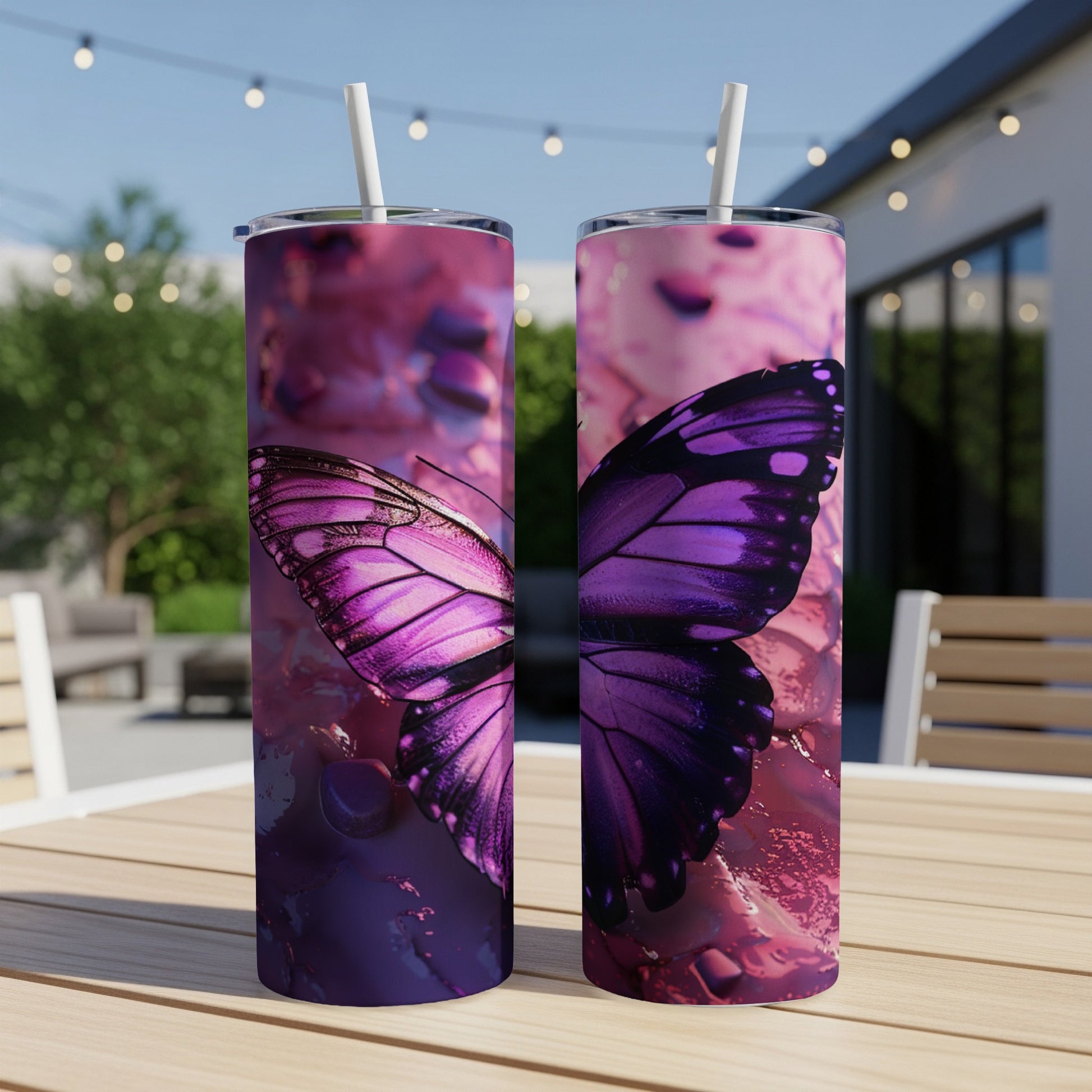 Two tumblers with purple butterfly wing design on a table.