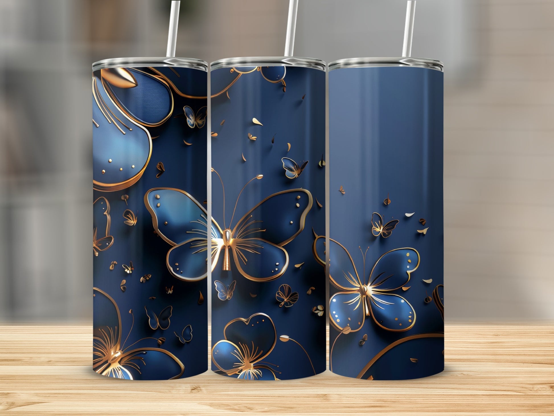 Three blue tumblers with gold butterfly and floral accents.
