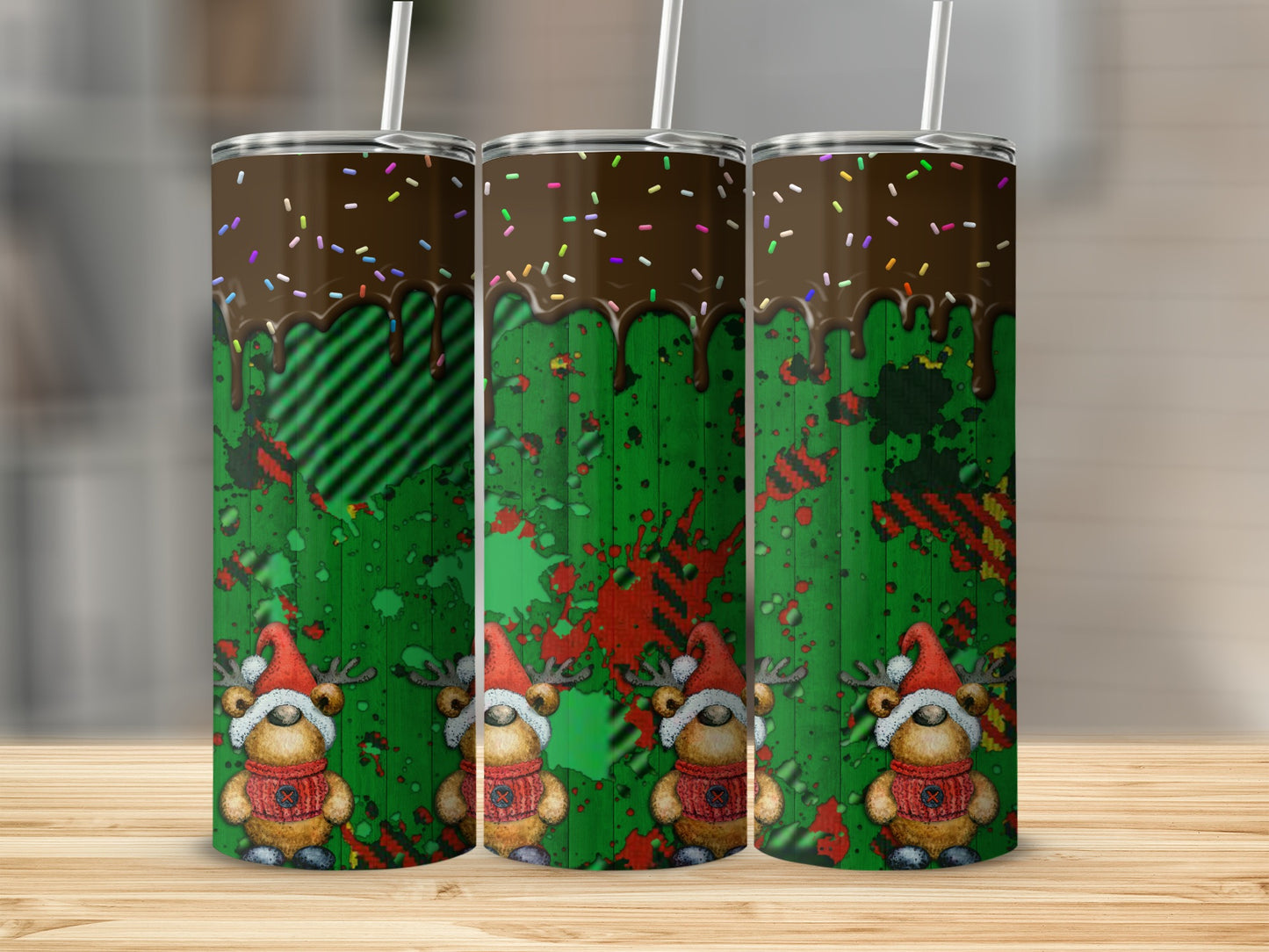 Three tumblers with dripping chocolate, plaid, and reindeer designs.