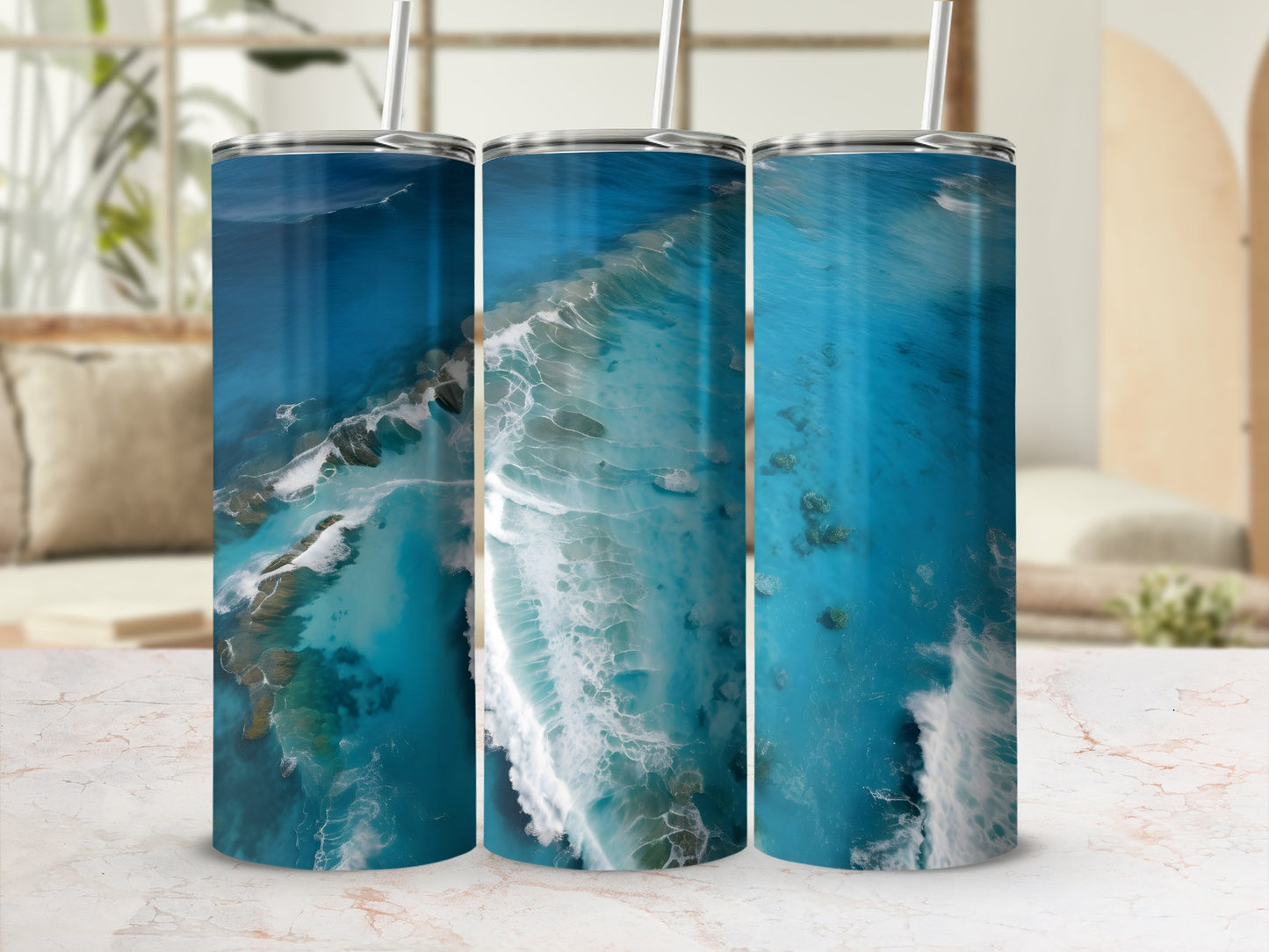 Three tumblers with ocean wave and coral reef designs.