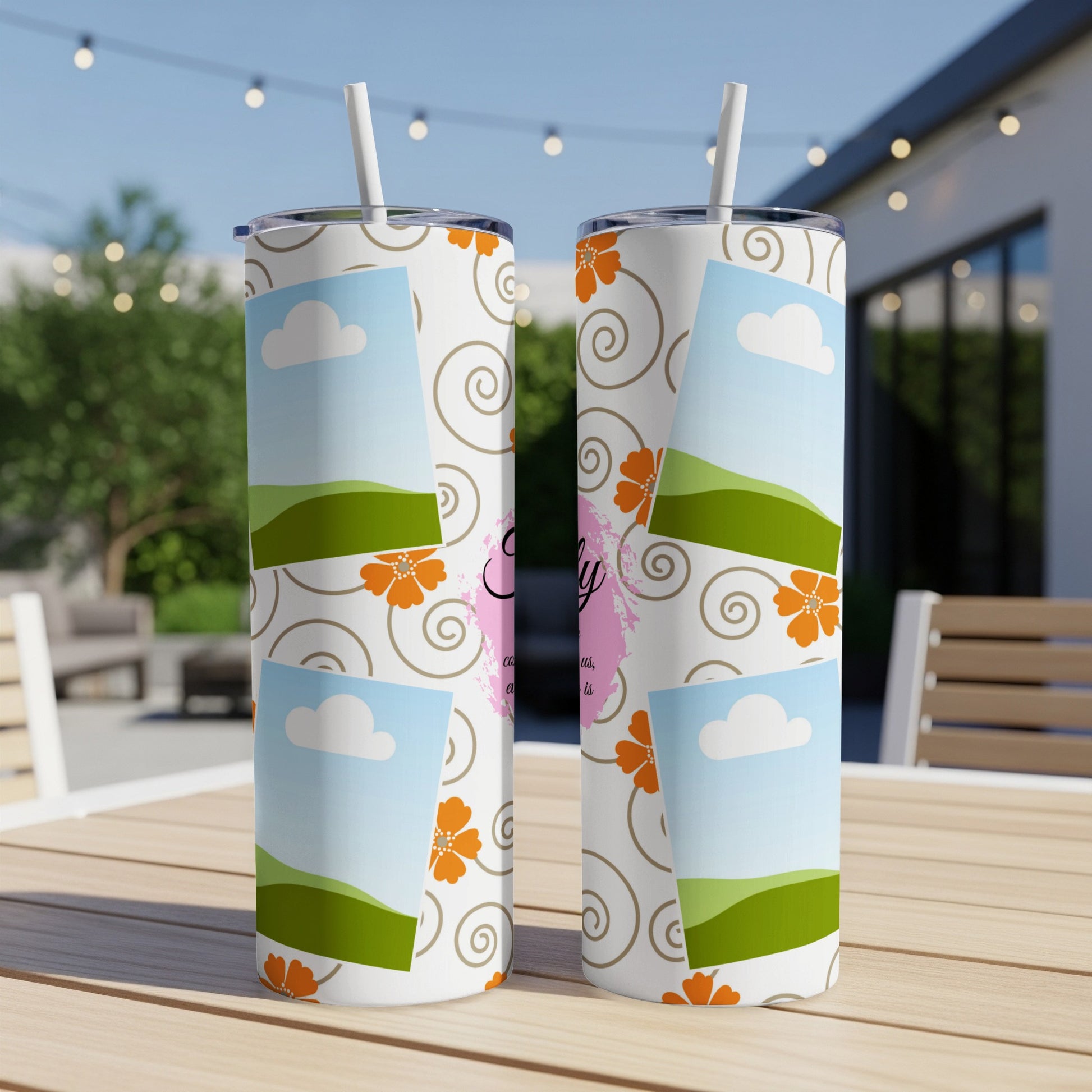 Two tumblers with a sky, clouds, hills, and floral design.