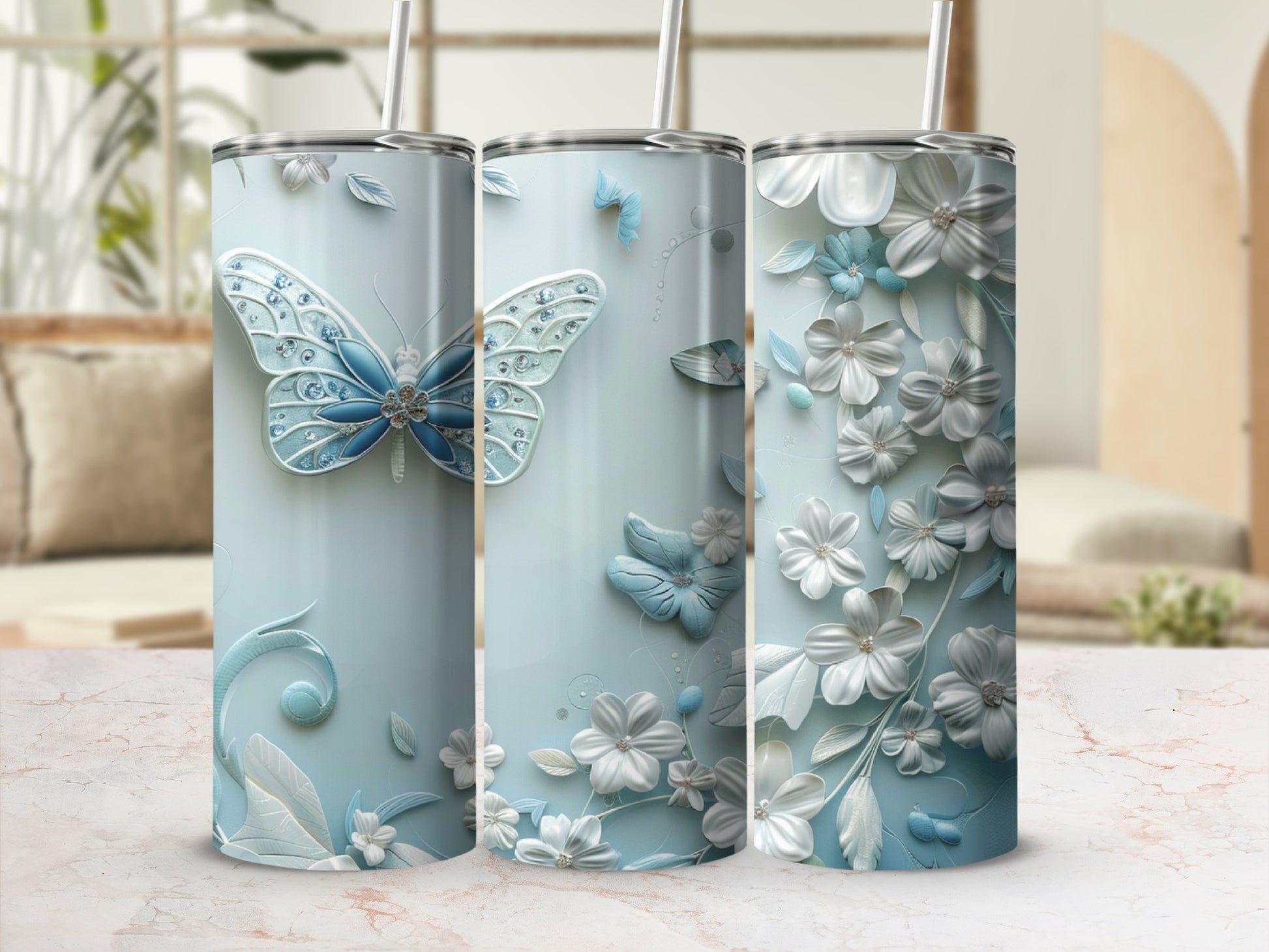 Three light blue tumblers with butterfly and floral designs.