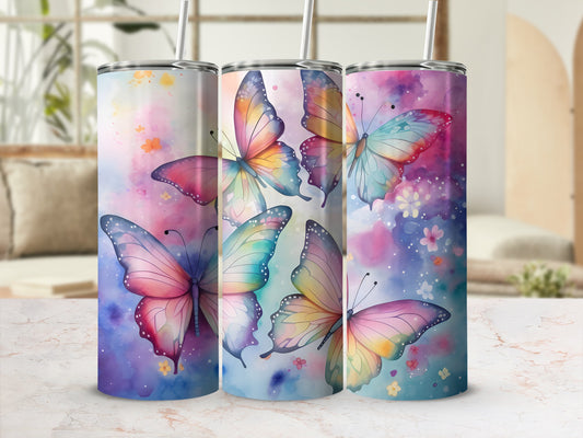 Three tumblers featuring colorful watercolor butterflies on a blurred floral background.