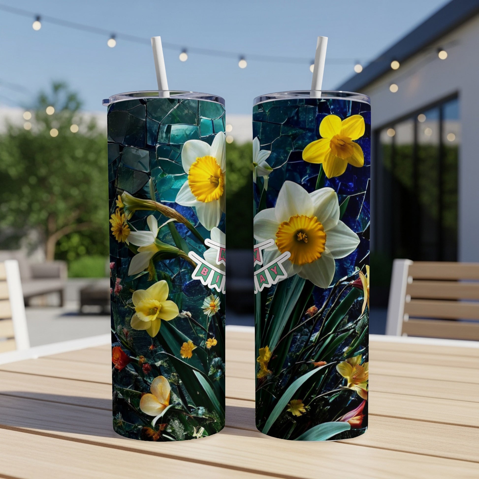 Two tumblers with white and yellow daffodils and tropical flowers.