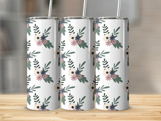 Three tumblers with a floral pattern sit on a wooden surface.