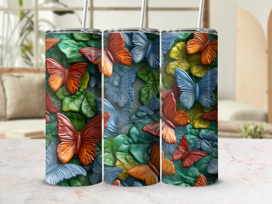 Tumbler with a mosaic of colorful butterflies and green leaves.