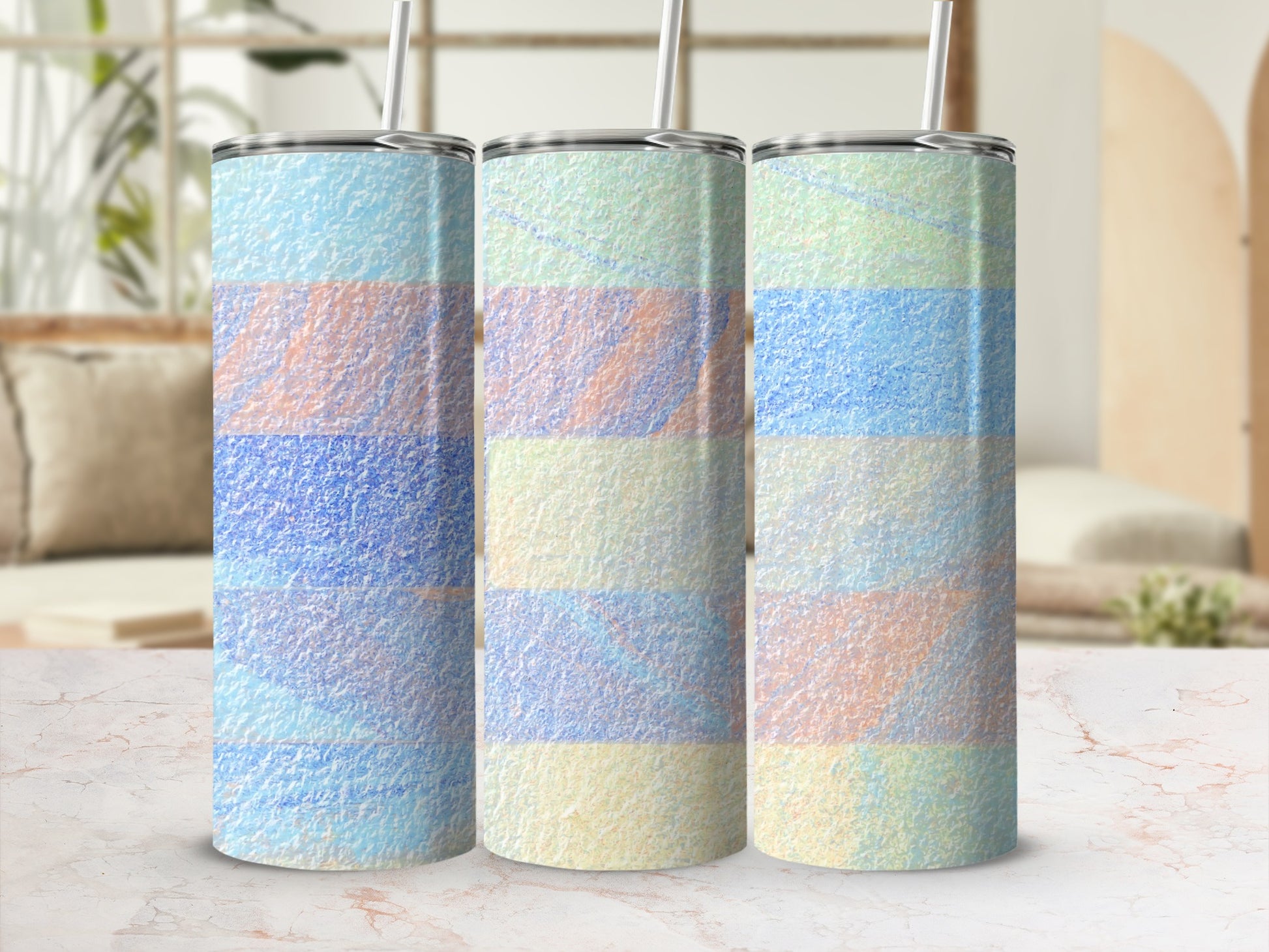 Three tall tumblers with a pastel striped pattern and straws.