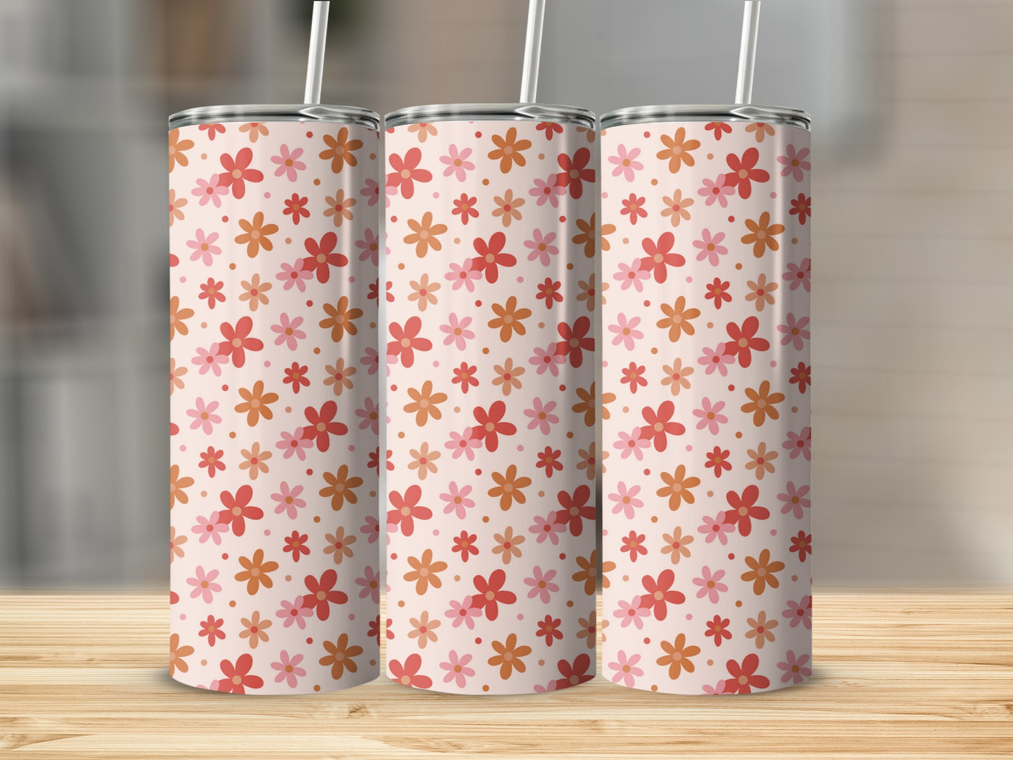 Three tumblers with a repeating pattern of pink and orange flowers.