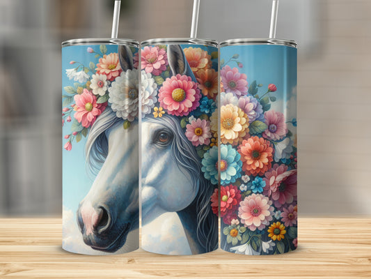 White horse with vibrant floral mane against blue sky.