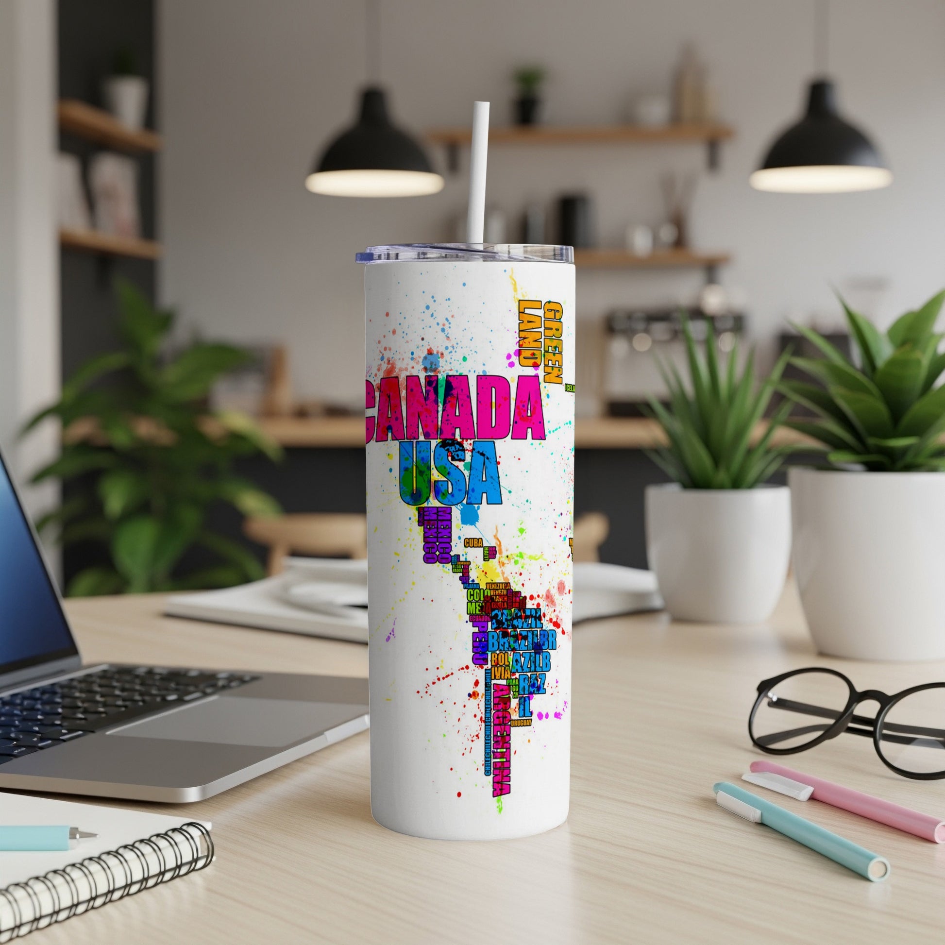 White tumbler with colorful map of the Americas and country names.