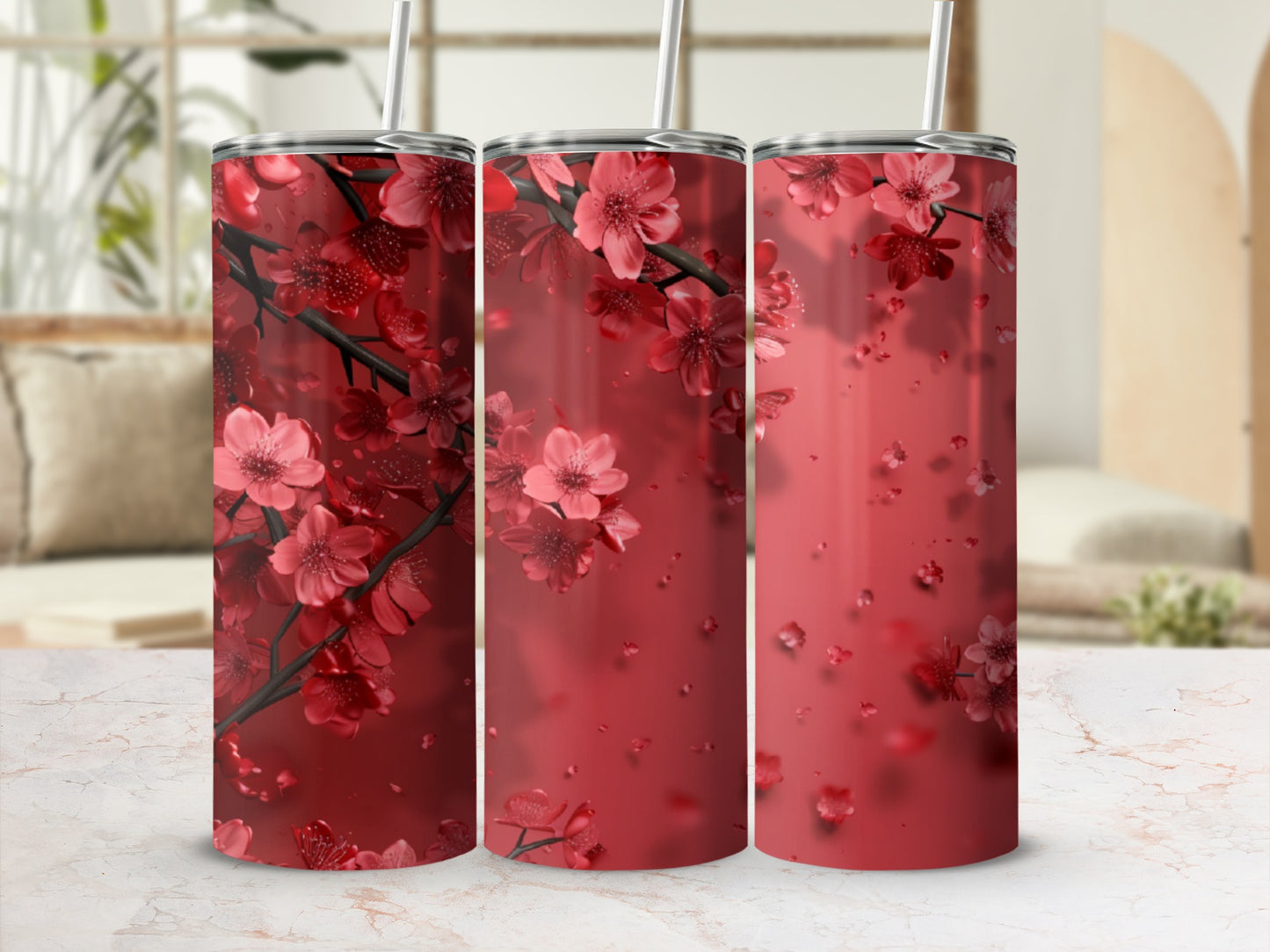 Three red tumblers adorned with blooming cherry blossoms.