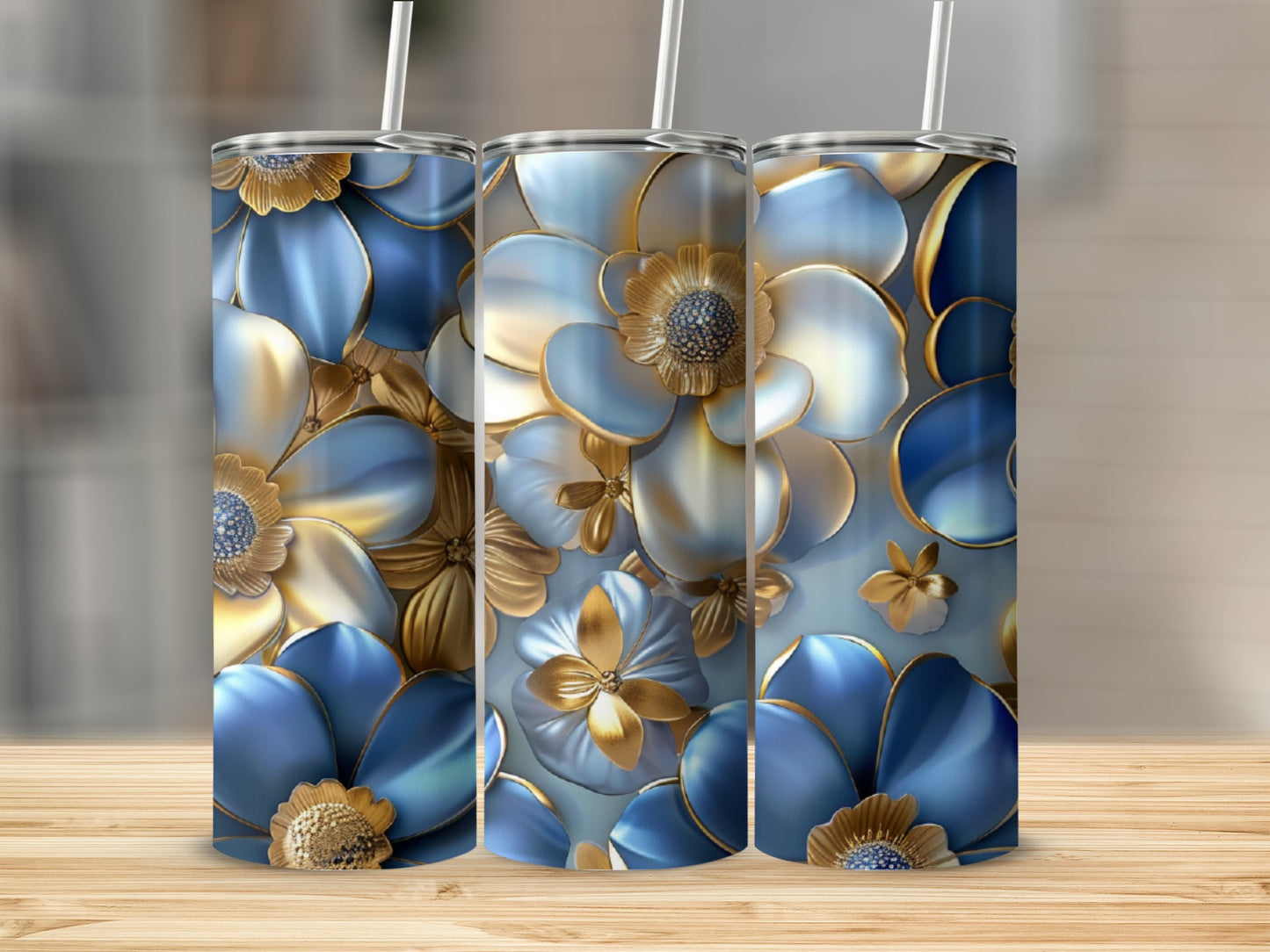 Three tumblers with blue and gold floral designs, standing on a wooden surface.
