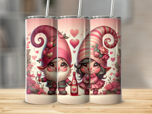 Two Valentine gnomes with pink hats, one holding wine, against floral background.