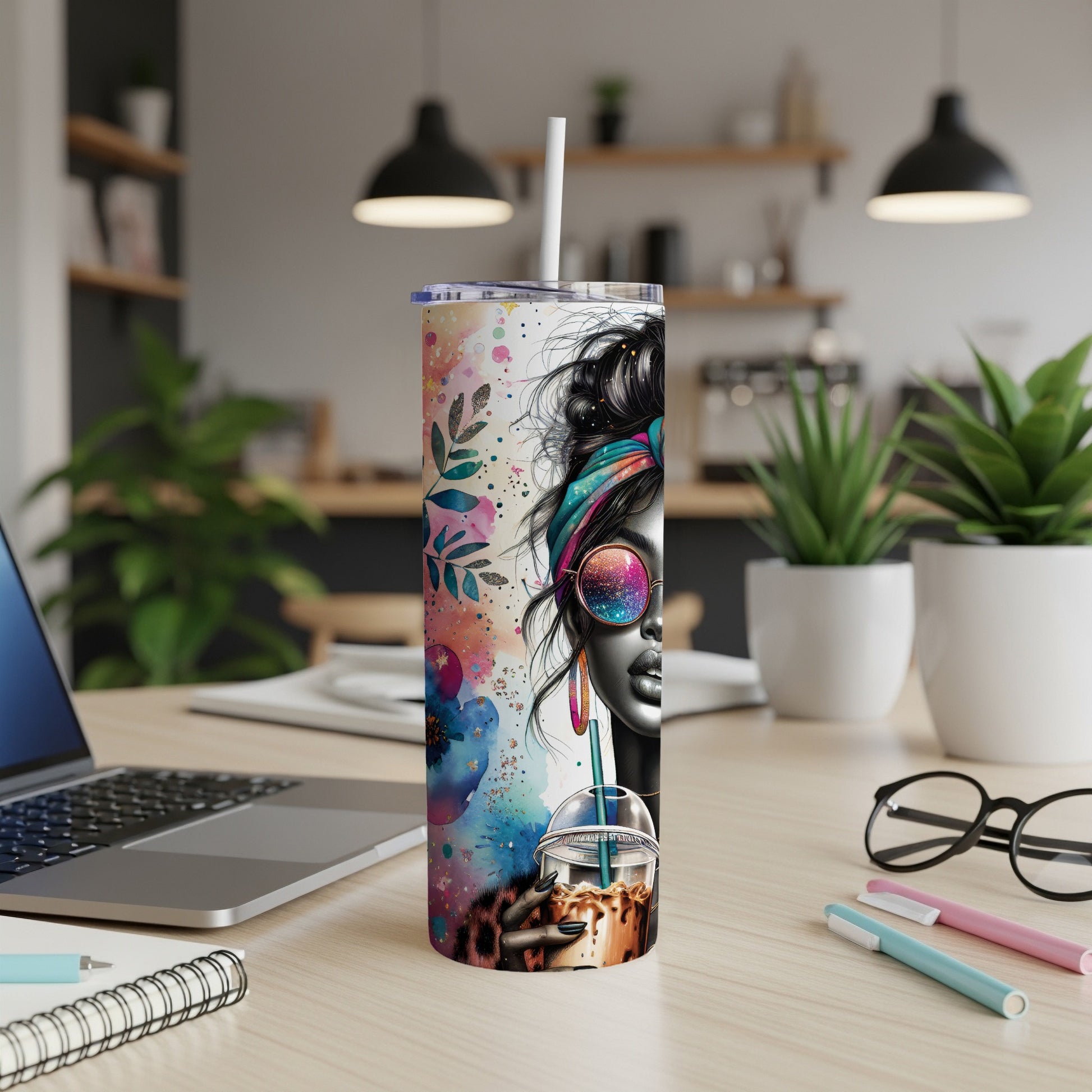 Tumbler with colorful abstract art and a woman's face wearing sunglasses and a headband.