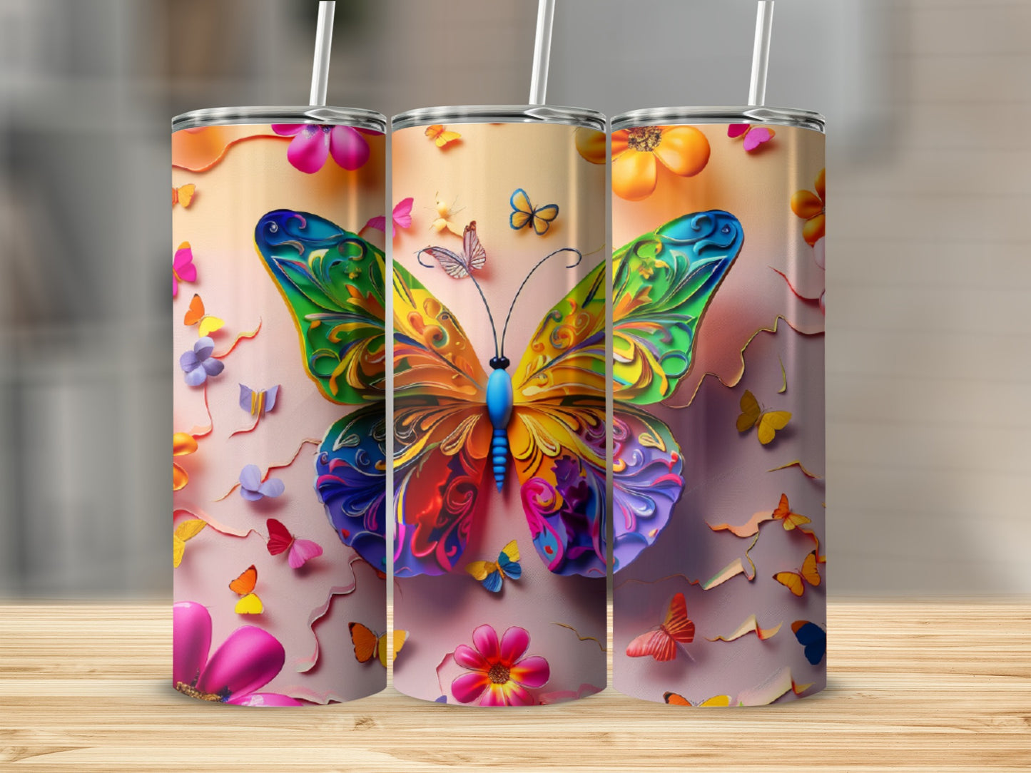 Three tumblers featuring colorful butterflies and floral designs on a wood surface.